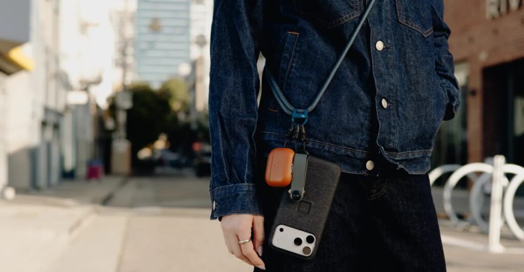 A word with a woman trying to pull off a crossbody phone strap
