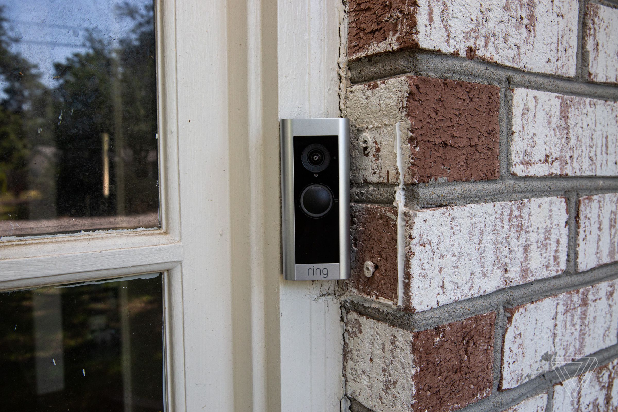 A Ring Video Doorbell Pro 2 mounted outside the front door of a house.