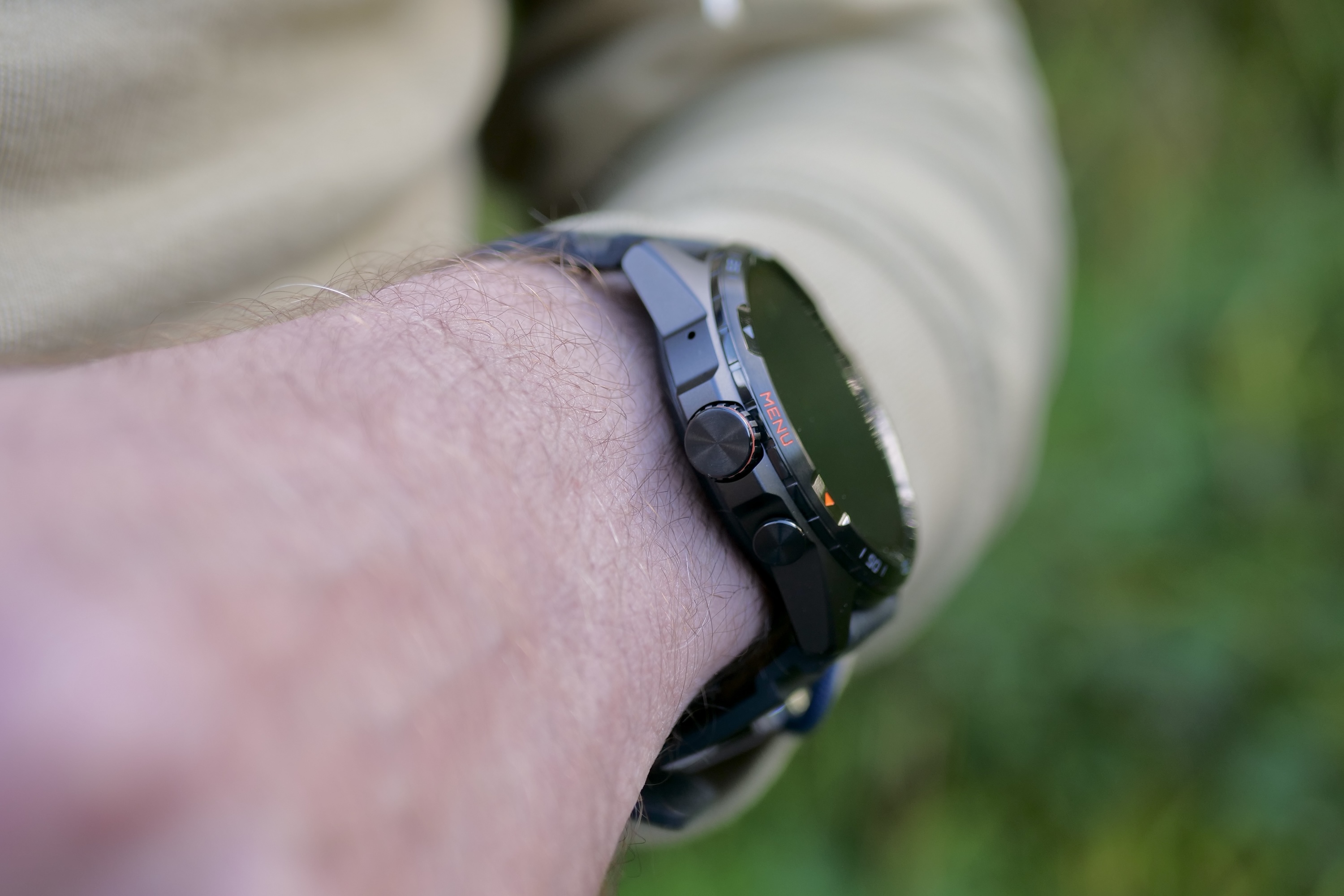 A person wearing the Mobvoi TicWatch Atlas, showing the crown.