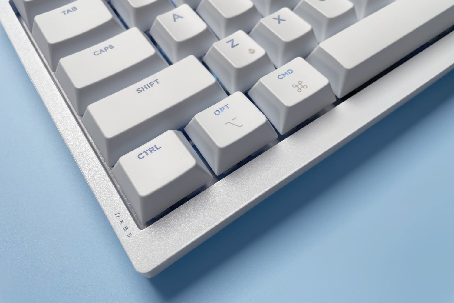 The Corsair K65 Plus for Mac keyboard against a blue background.