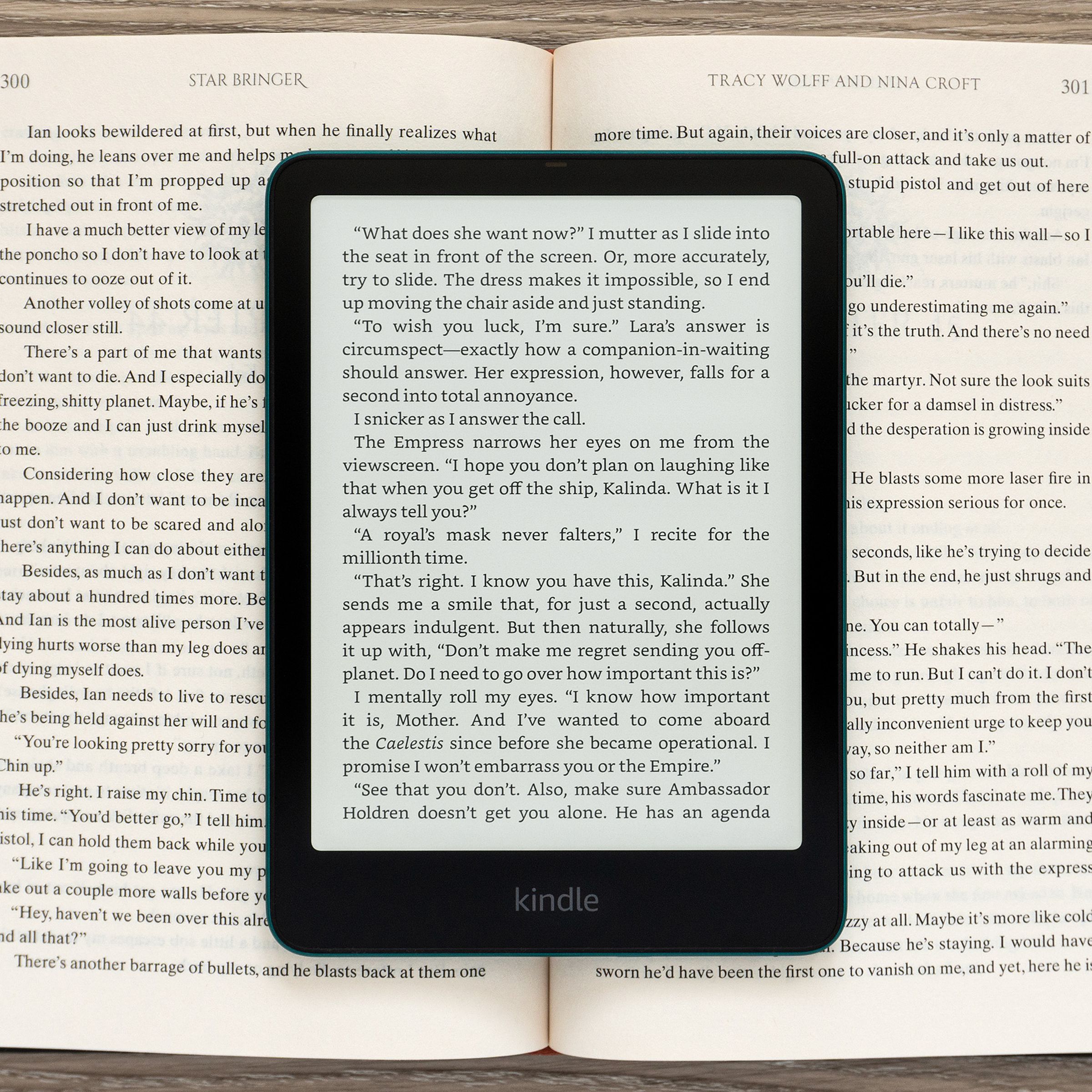 The Amazon Kindle Paperwhite Signature Edition (2024) displaying a page of text sitting on an open book.