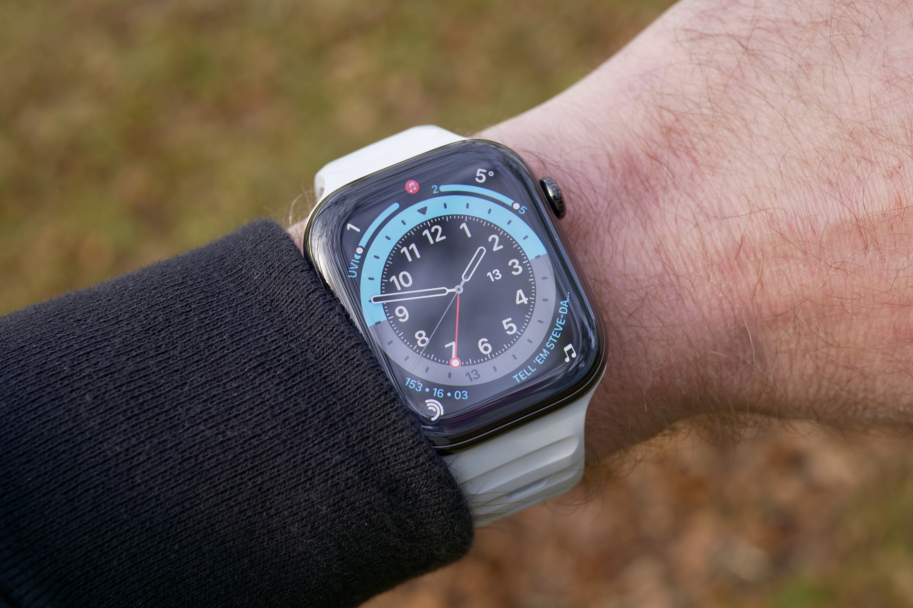 A person wearing the Nomad Sport Band in the Icy Blue glow-in-the-dark finish.