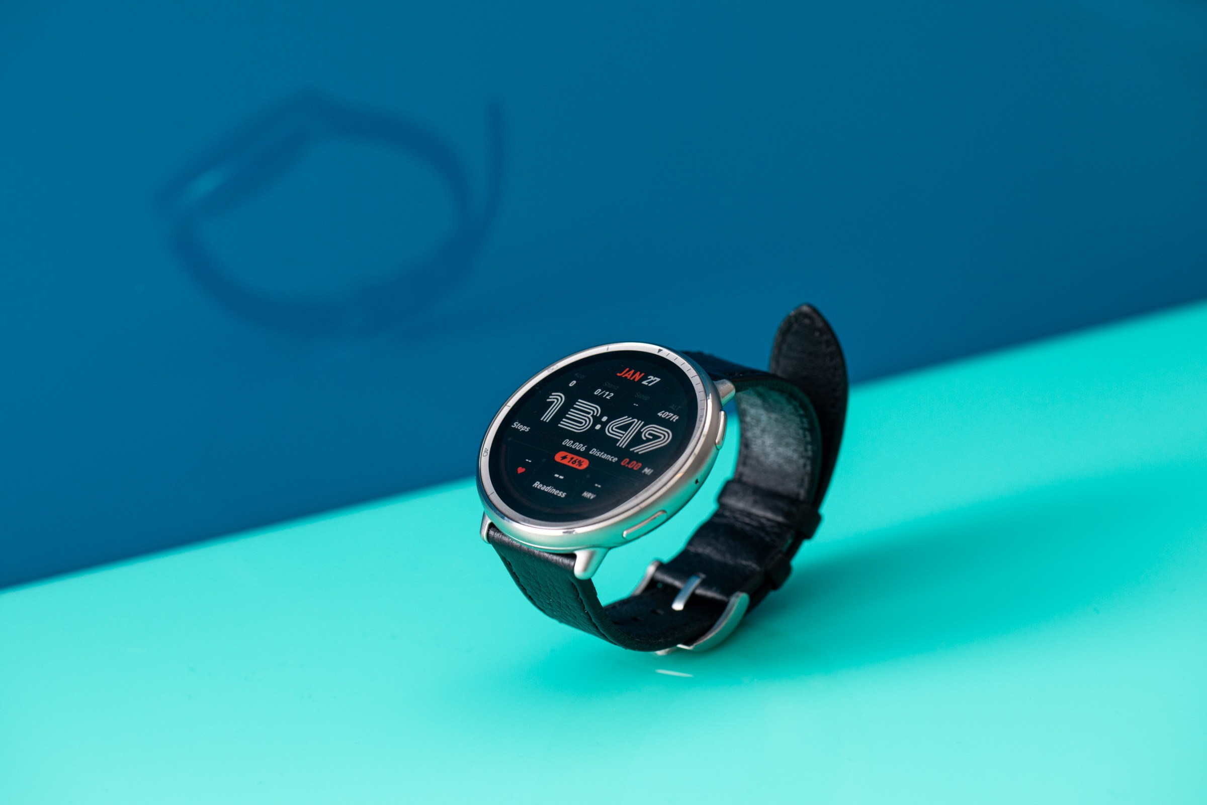 Angled view of the Amazfit Active 2 showing a stylish retro watch face against a bright blue background