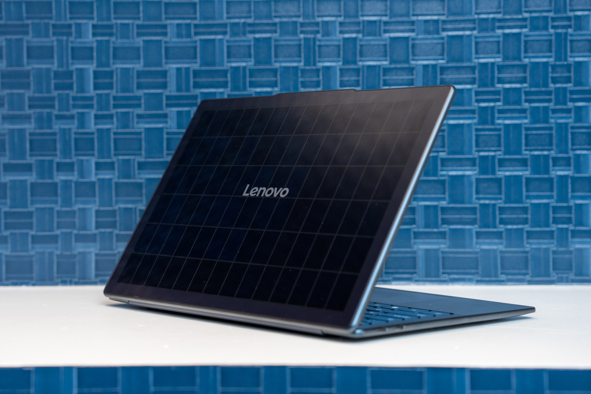 The Lenovo Yoga Solar PC on a white table in front of a blue tile backdrop.