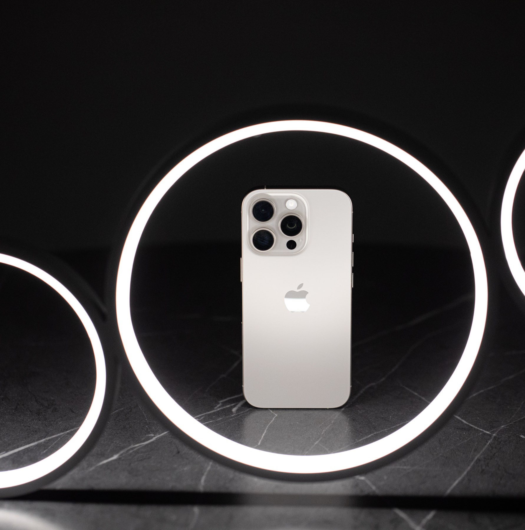 The iPhone 16 Pro in a ring-shaped LED light fixture.