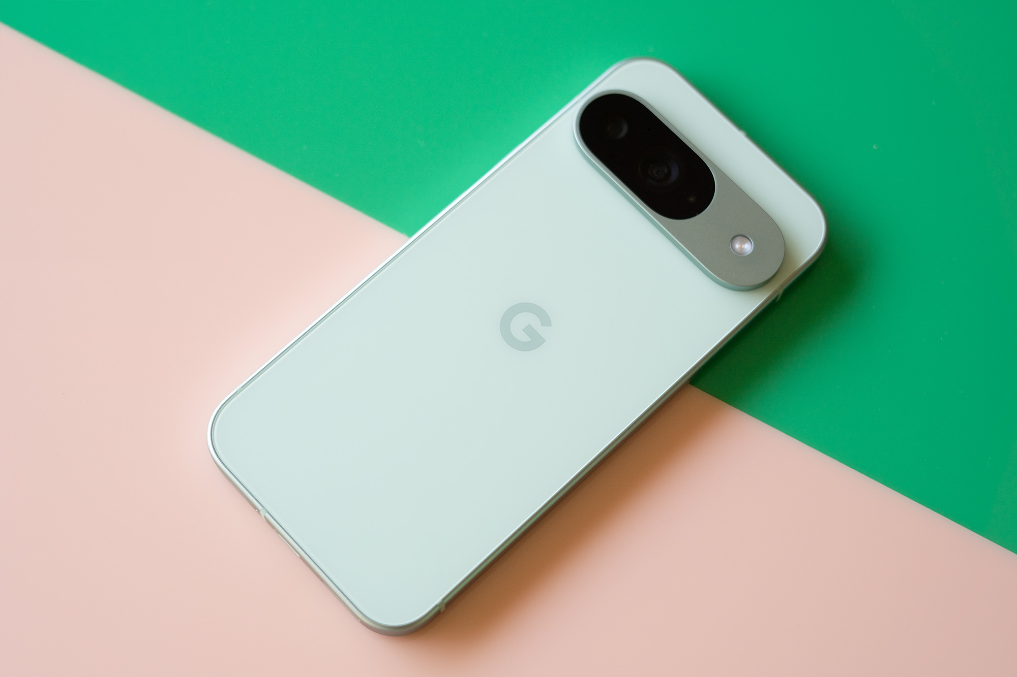 Google Pixel 9 on a pink and green background.