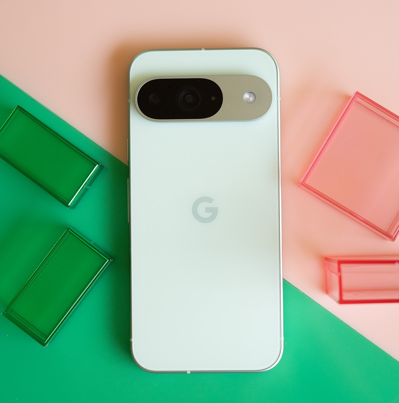 Google Pixel 9 on a pink and green background.