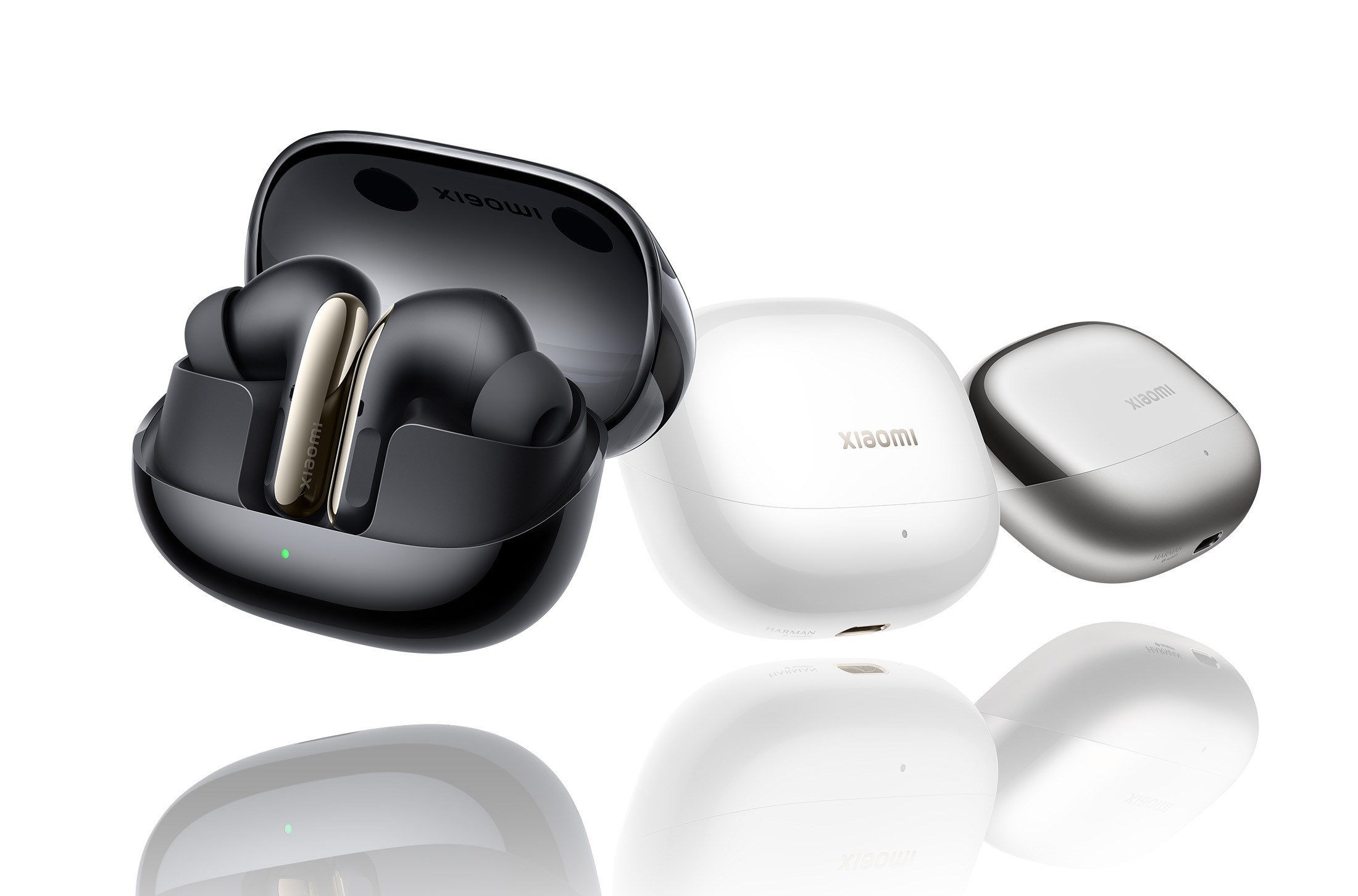 The Xiaomi Buds 5 Pro in three different charging cases.