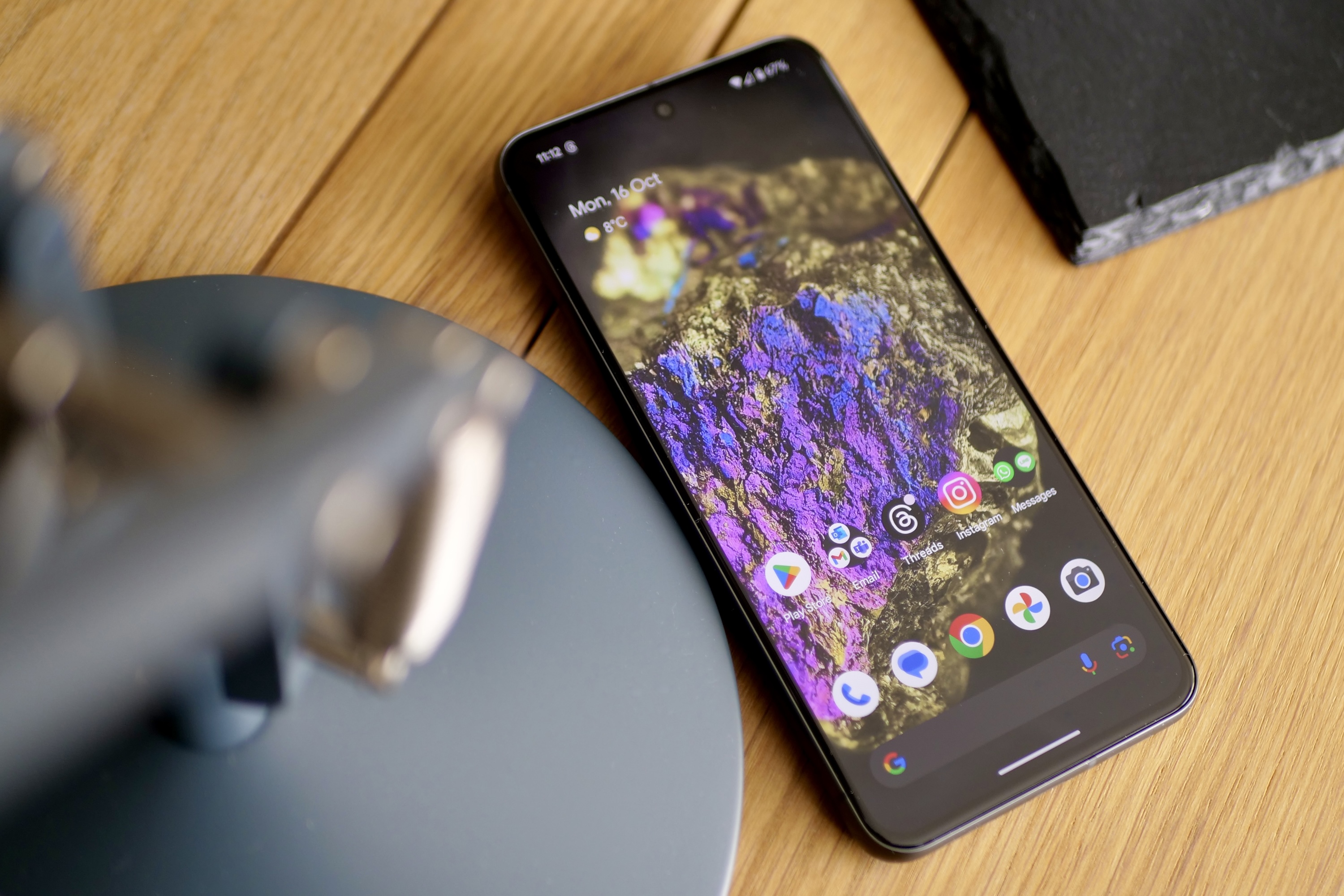 The Google Pixel 8 on a table showing the screen.