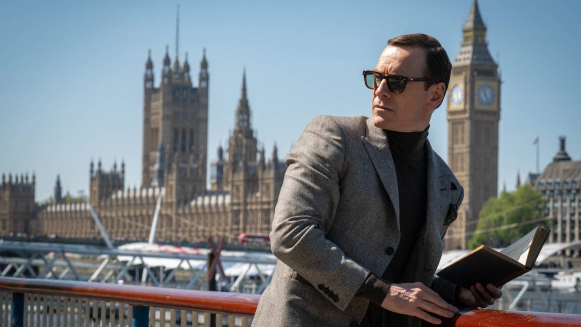 Michael Fassbender leans against a wall and looks the other way in Black Bag.