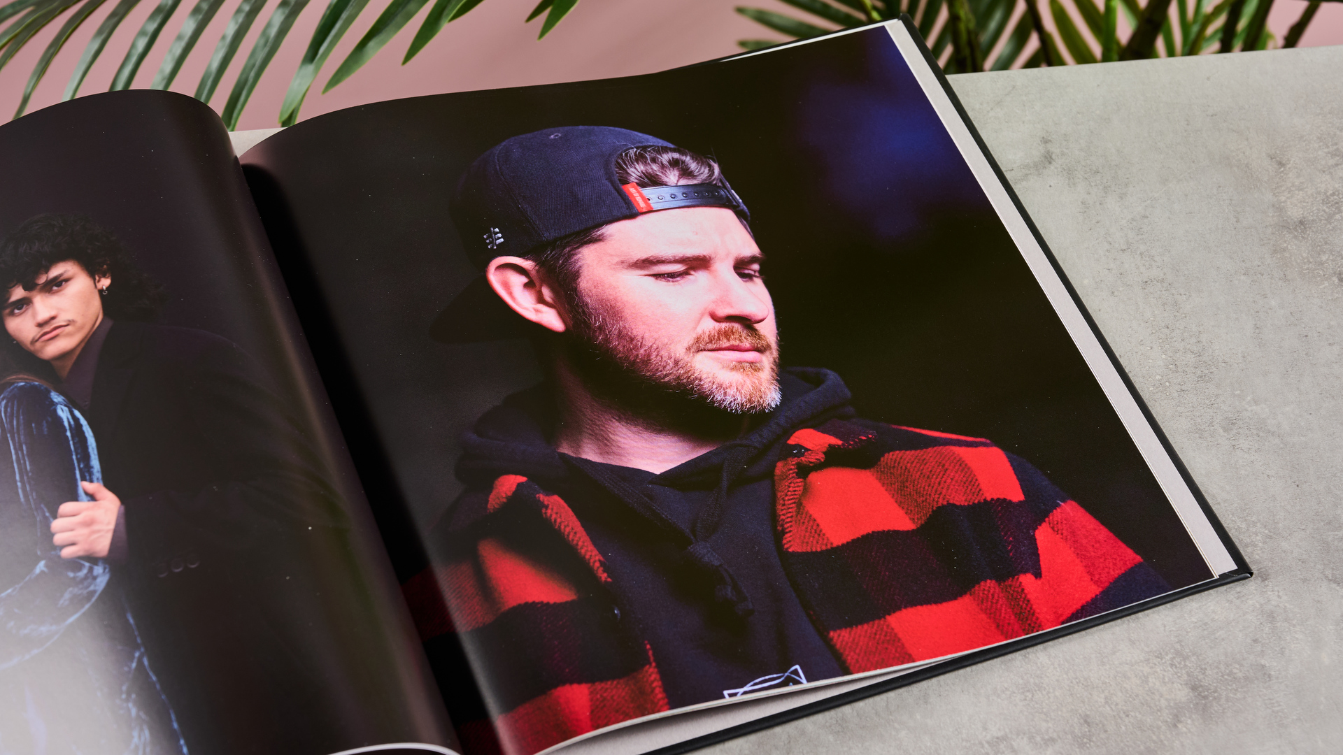 The interior of Blurb photo book showing a man wearing a backward baseball cap, checked shirt and a well-kempt beard.