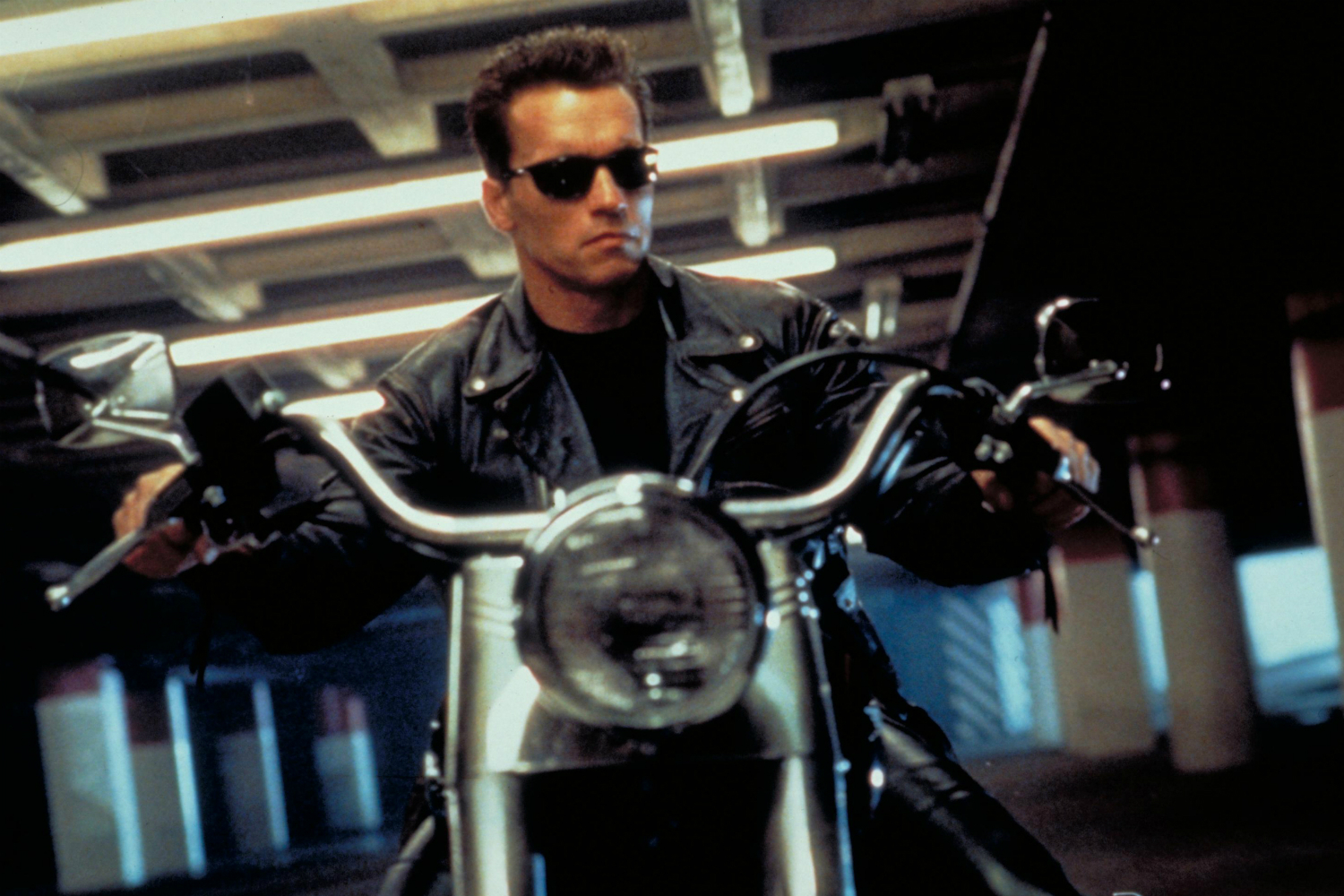 Arnold Schwarzenegger riding a motorcycle in
