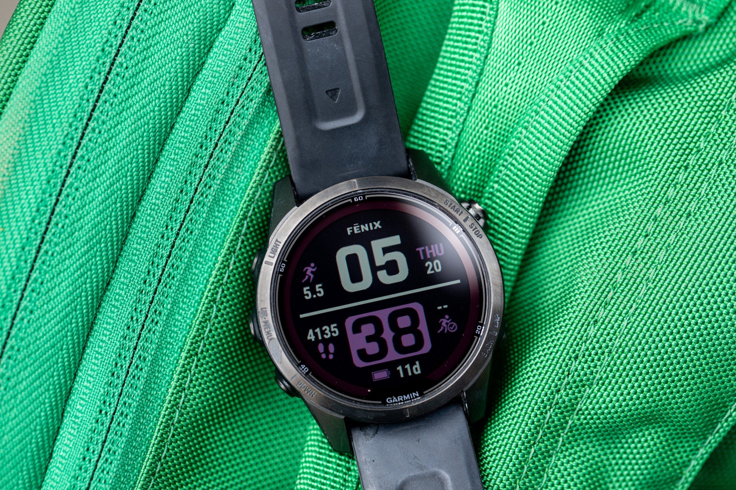 The Fenix 7S Pro on top of a green backpack