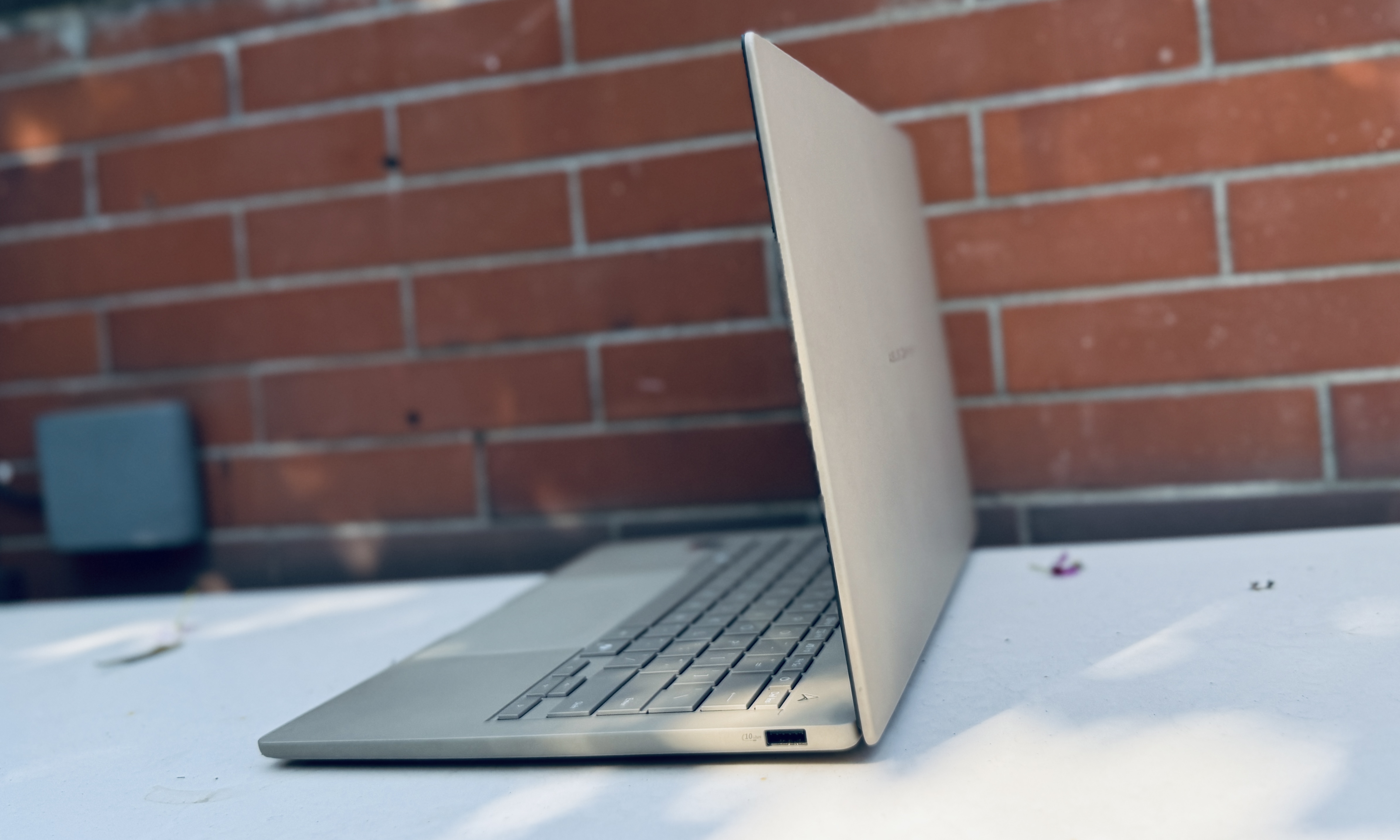 Angled view of Asus ZenBook A14 laptop with lid open.
