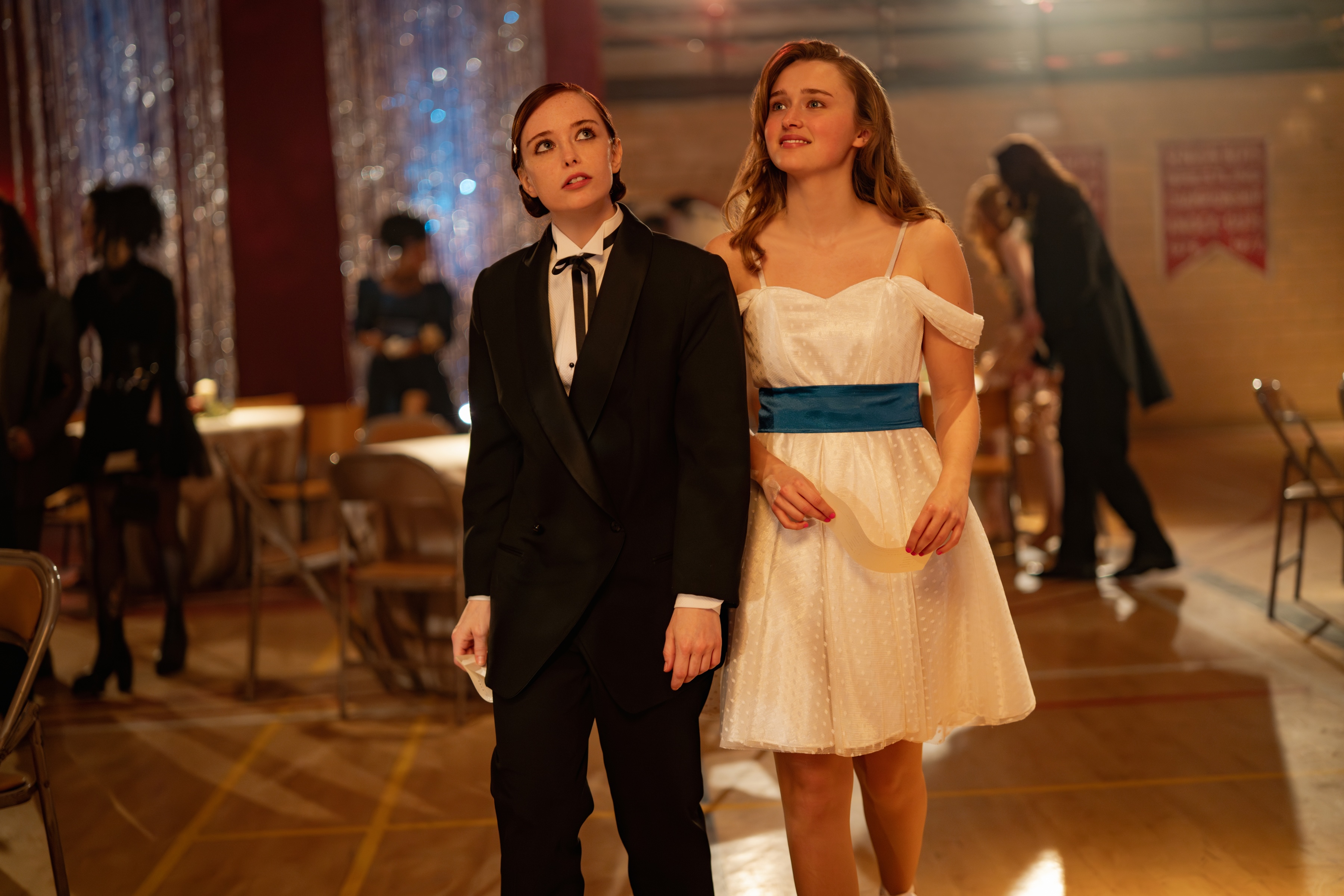 Two girls walk on the dance floor in Fear Street: Prom Queen.