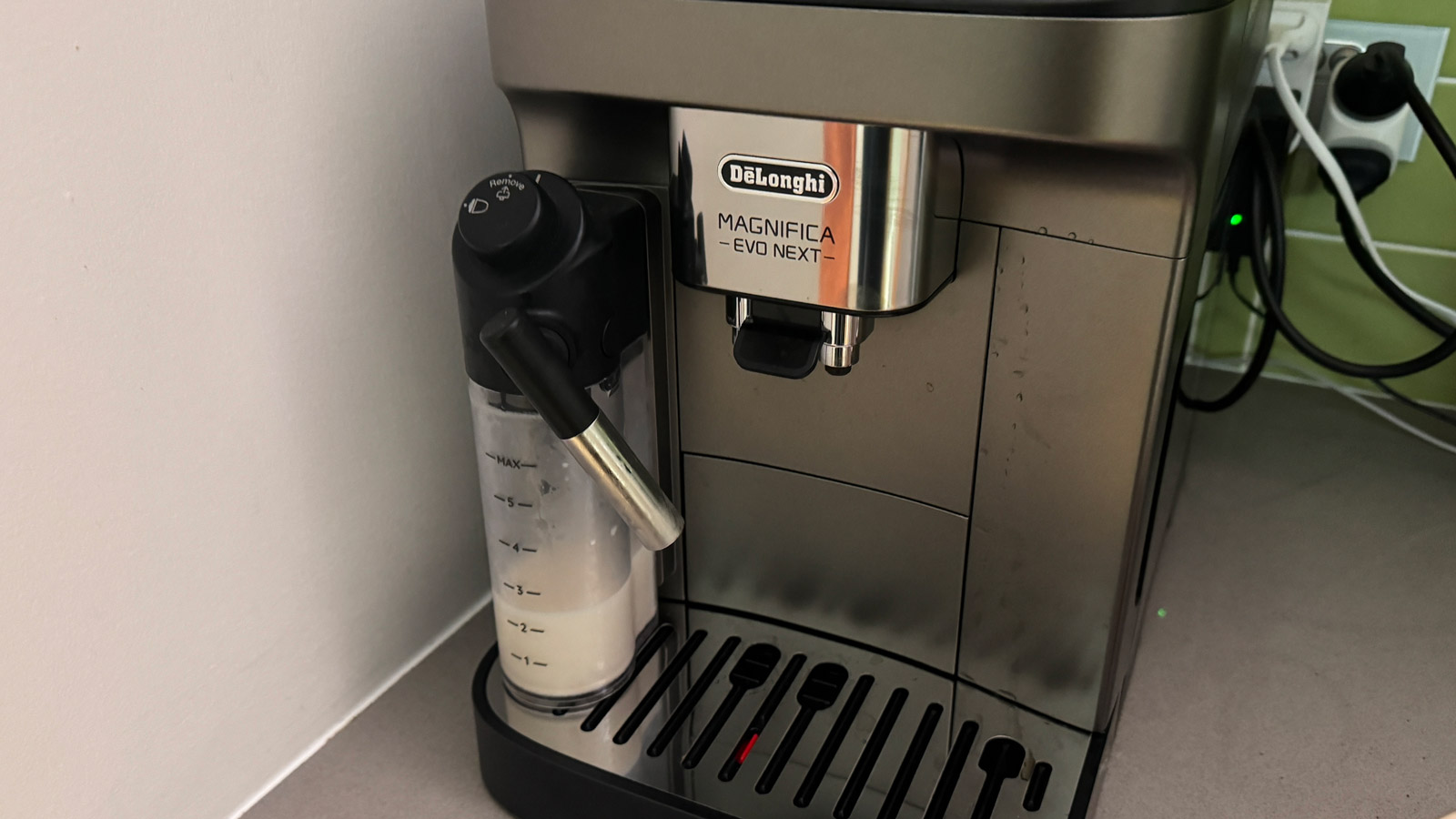 De'Longhi Magnifica Evo Next coffee machine with its milk carafe attached.