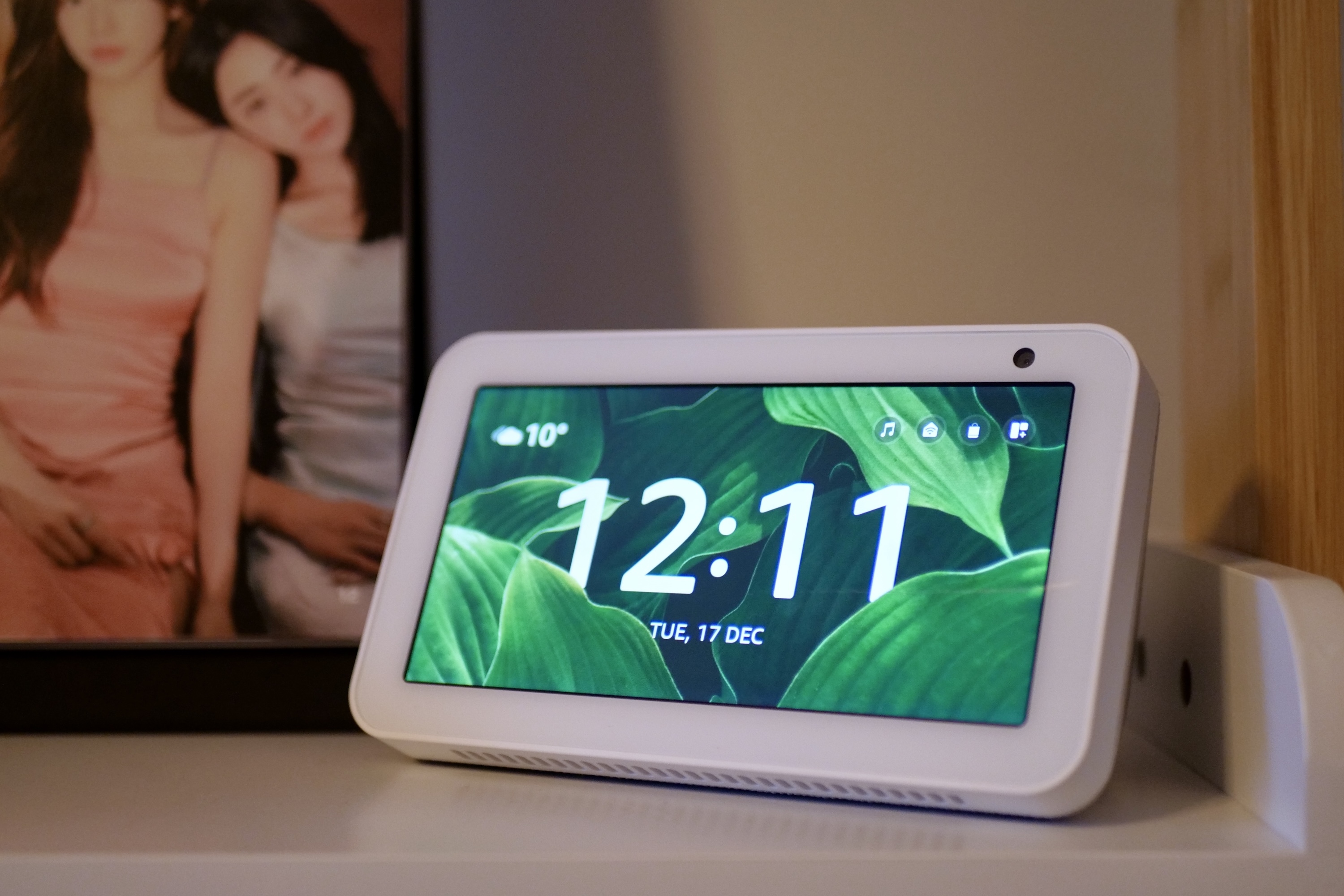 An Amazon Echo Show 5 on a shelf.