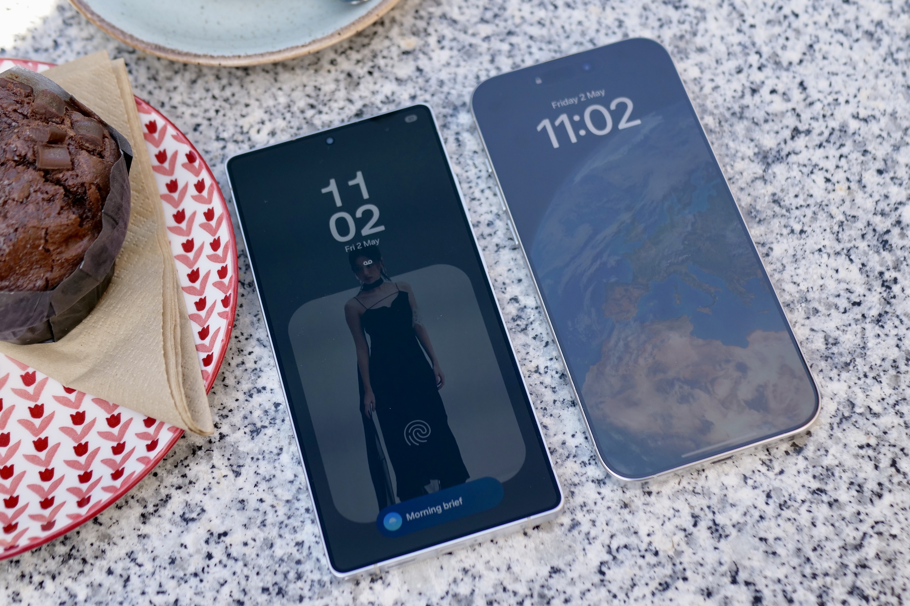 The Samsung Galaxy S25 Ultra with the Apple iPhone 16 Pro Max, showing the screen reflection.