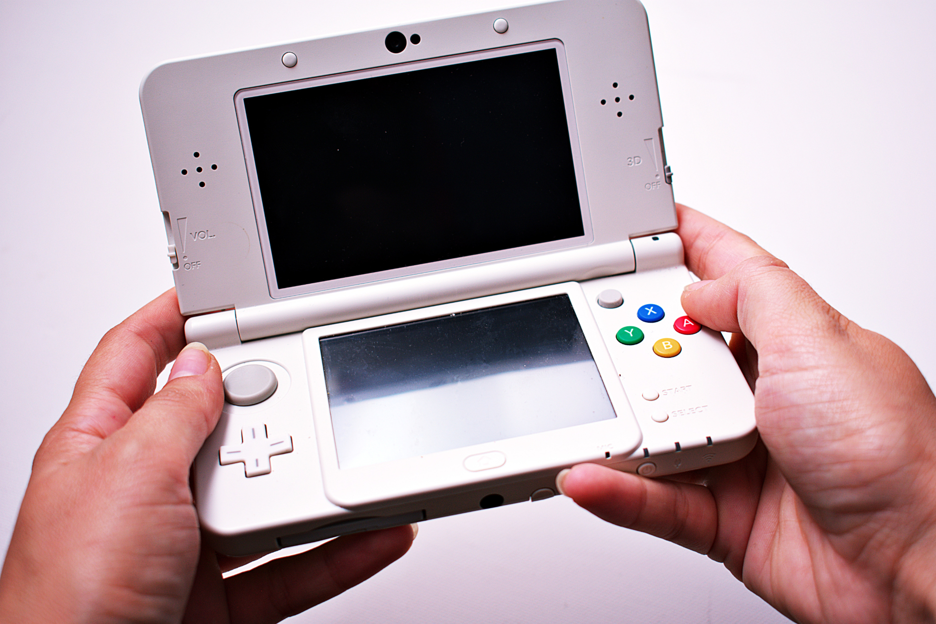 Person holding Nintendo 3DS in hands