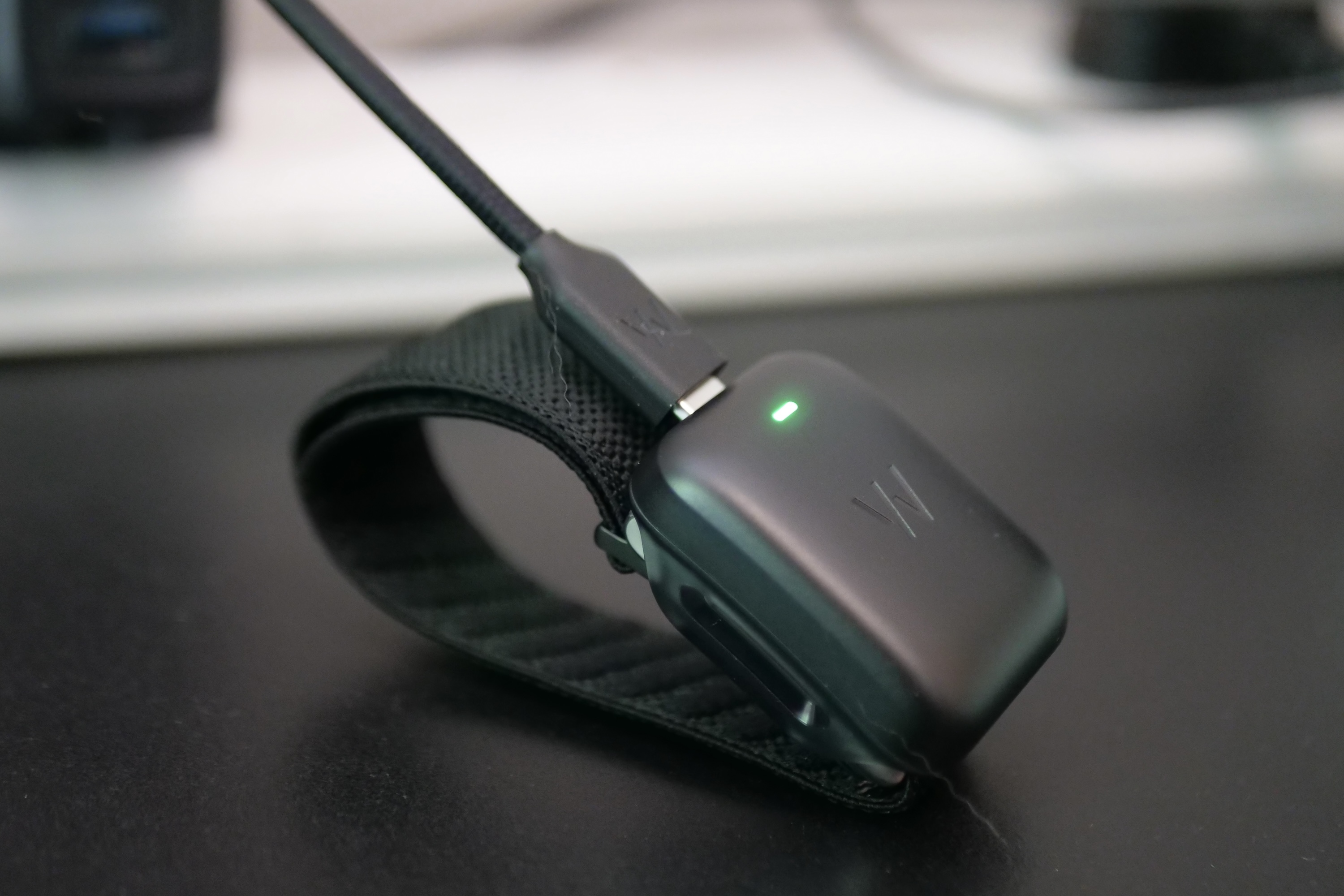 The Whoop 5.0 on charge.