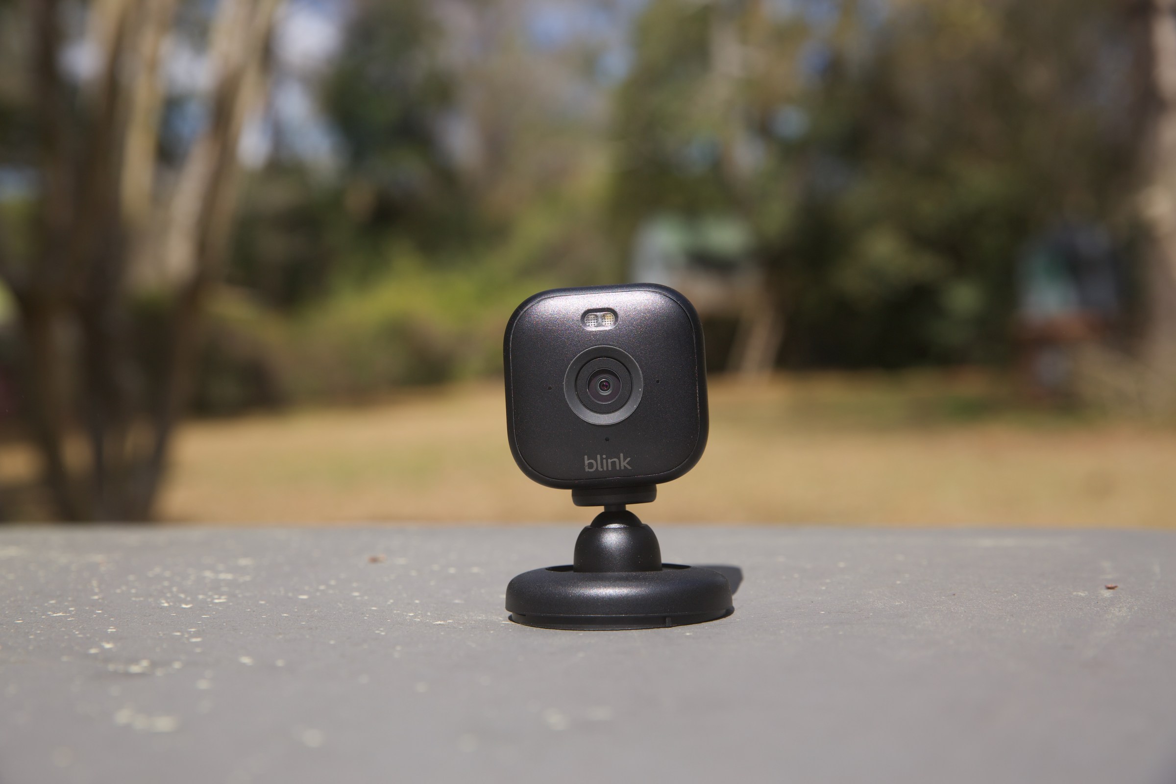 The Blink Mini 2 sitting on a table outside.