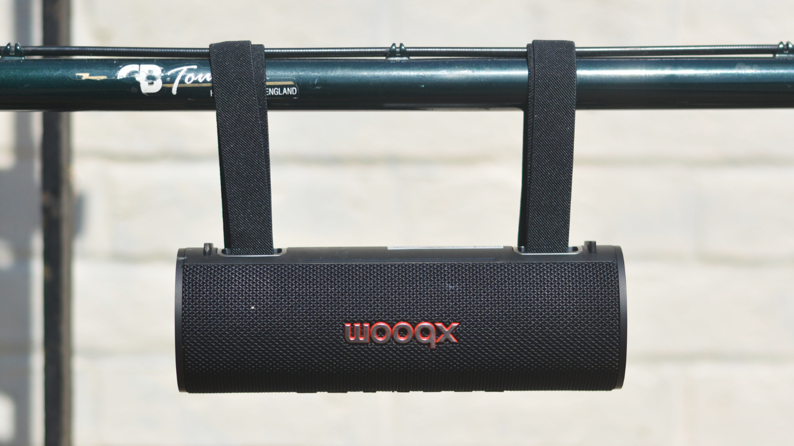 LG xboom Grab Bluetooth speaker in an outdoor setting