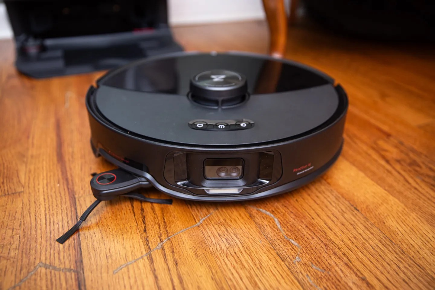The front of the Roborock S8 MaxV Ultra as it rests on hardwood floor.