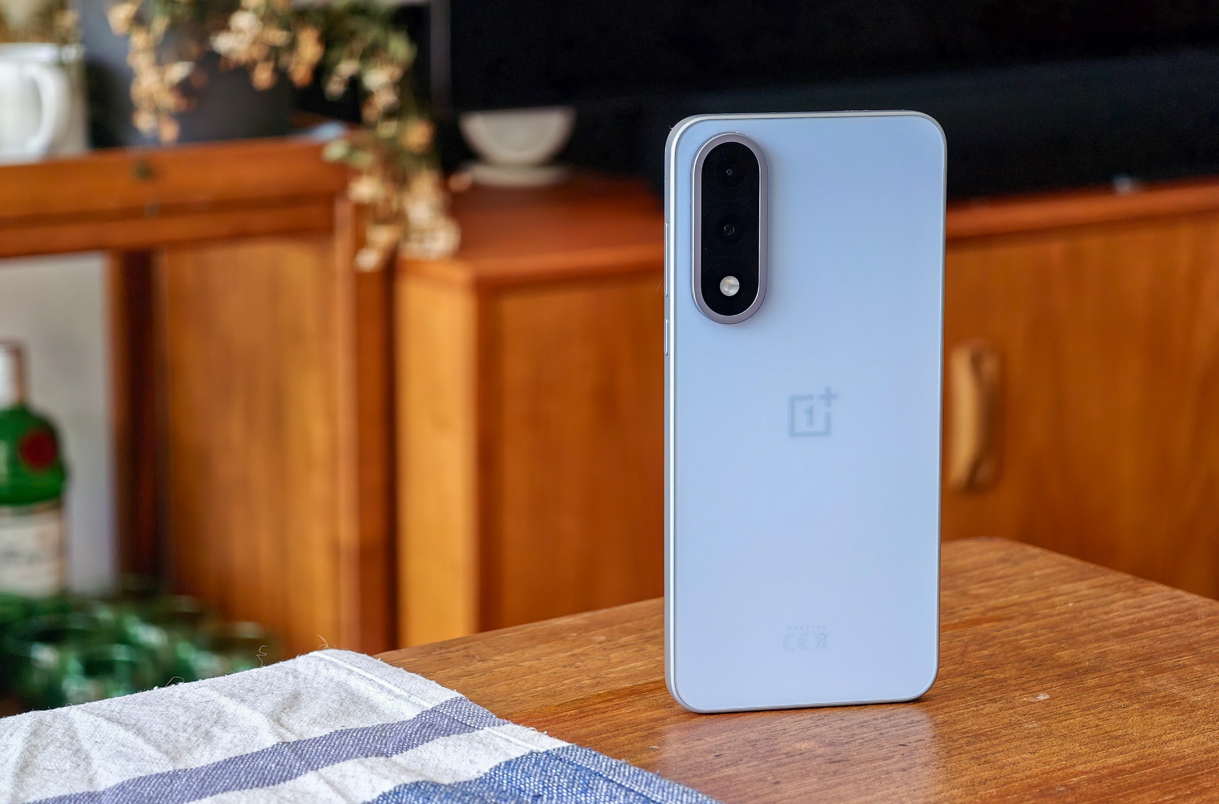 Photo of the OnePlus Nord 5 on a wooden table.
