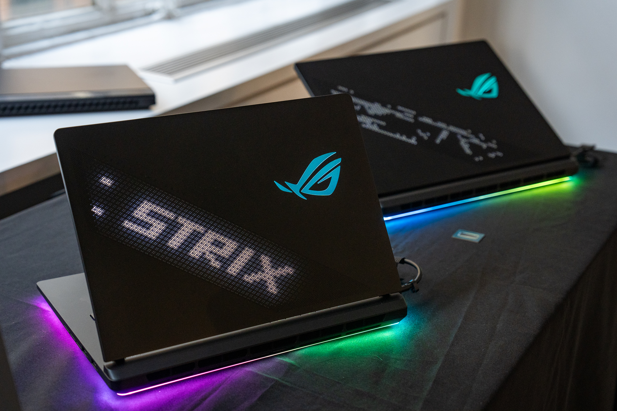 ROG Strix Scar 16 and 18 with lights around base.