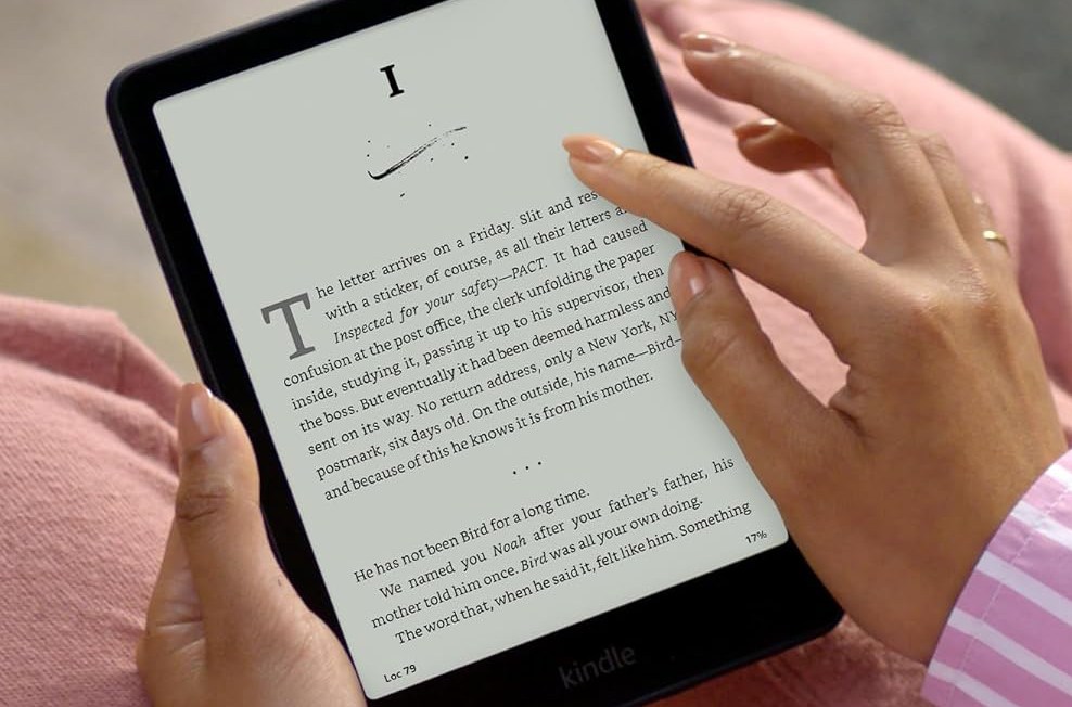 Two hands holding a Kindle.