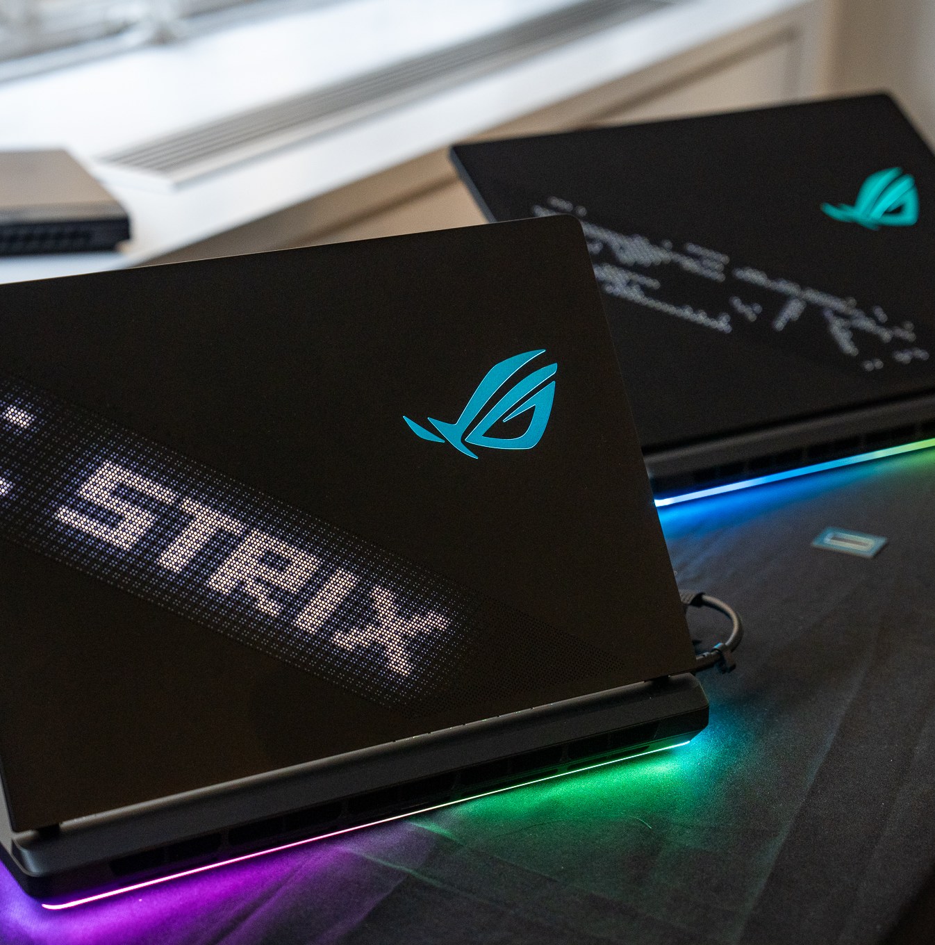 ROG Strix Scar 16 and 18 with lights around base.