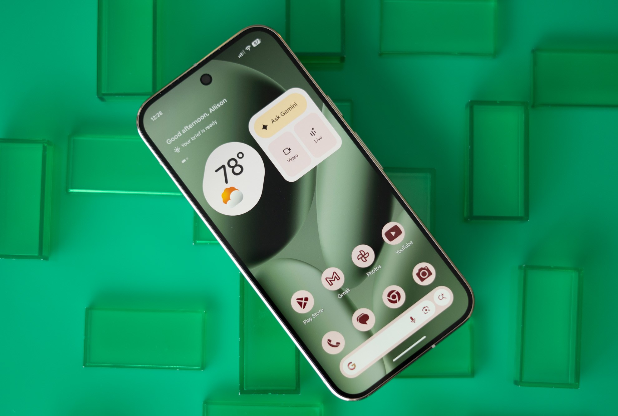 Google Pixel 10 Pro showing home screen on a green background