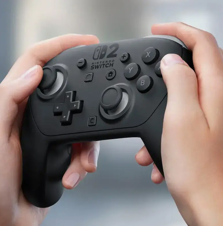 A close-up image of a pair of hands holding the Nintendo Switch 2 Pro Controller at a slight angle.