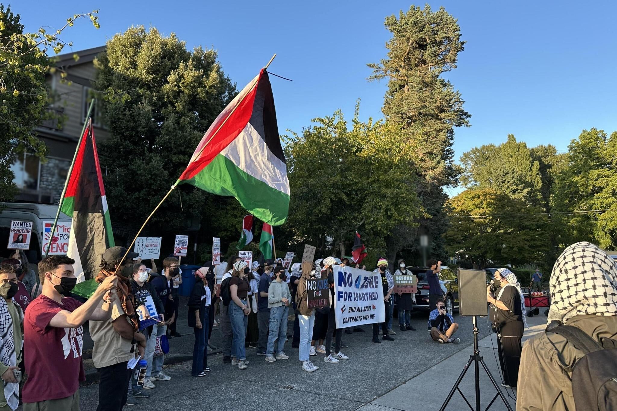 Protesters also carried wanted signs and banners (blurred to remove details).