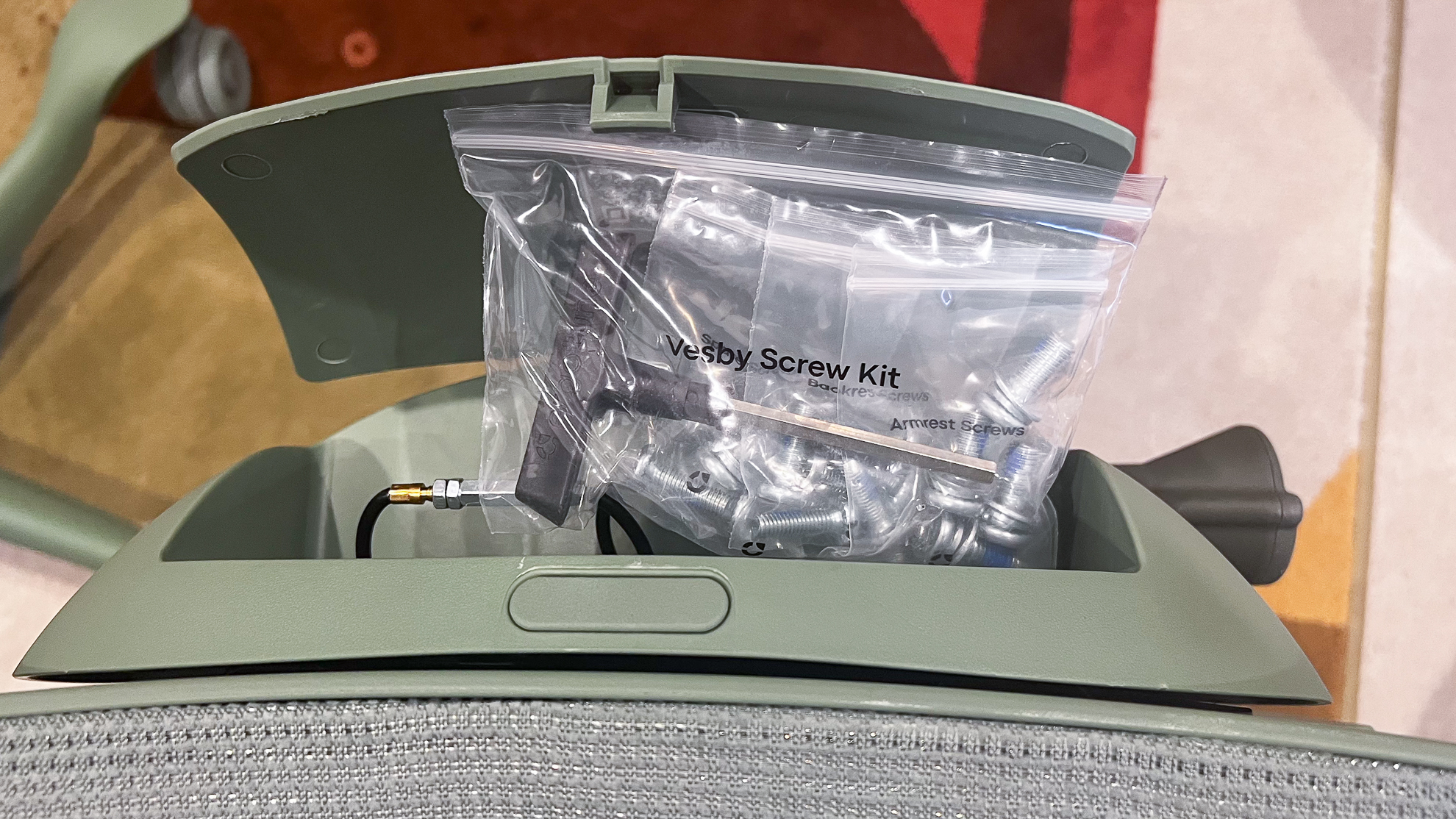 Hatch under the seat of the ErgoTune Vesby office chair holding bags of tools