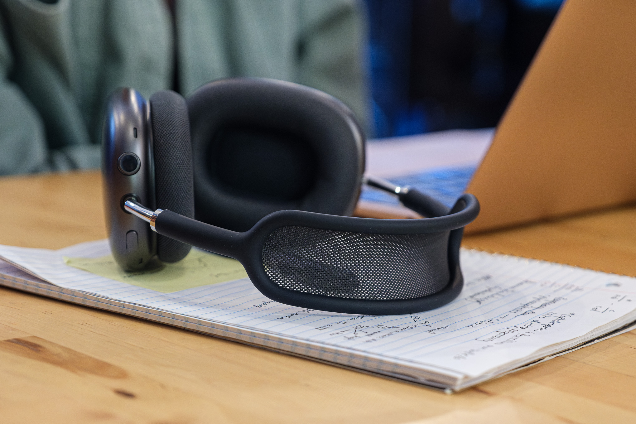 A photo of Apple’s AirPods Max headphones on a coffee shop table.