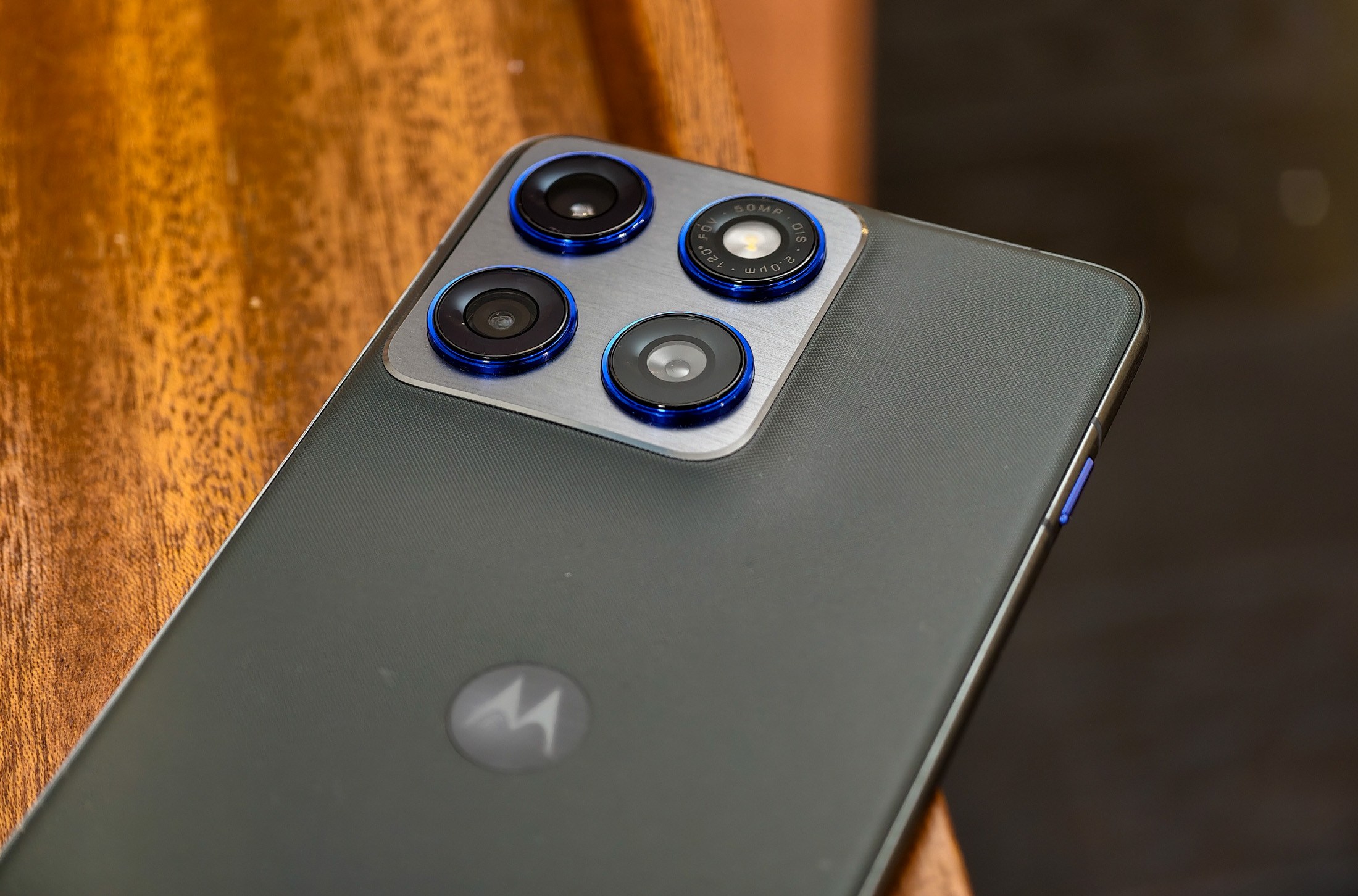 Photo of Motorola Edge 70 lying on a wooden table showing the cameras