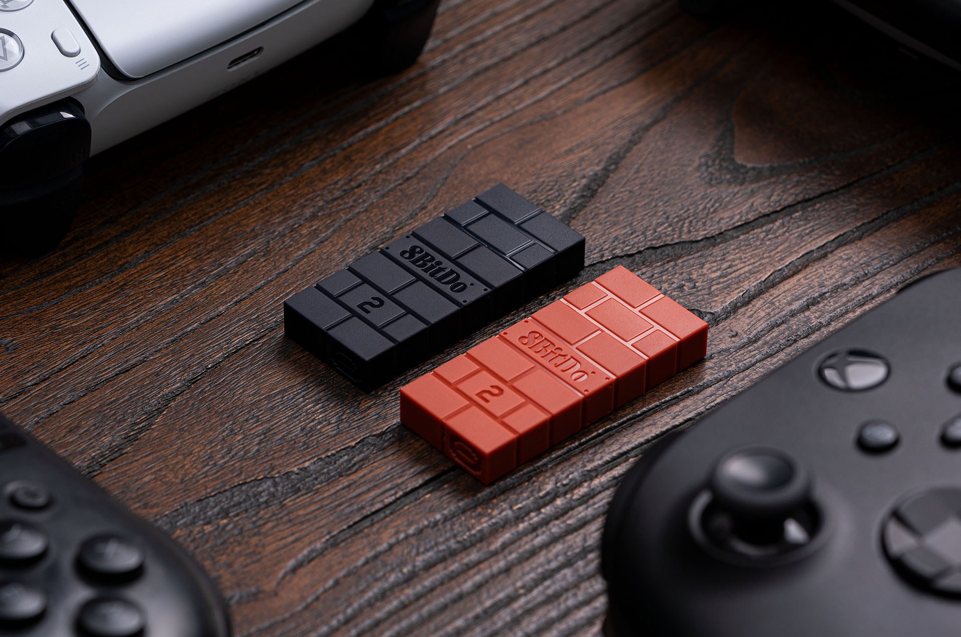 Photo of two 8Bitdo USB Wireless Adapter 2 units on wooden table