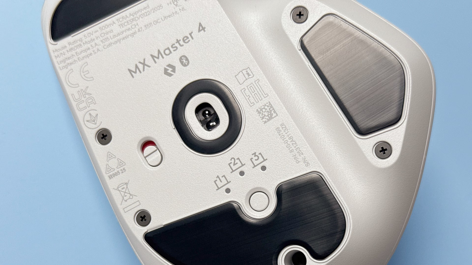 The Logitech MX Master 4 mouse against a blue background.