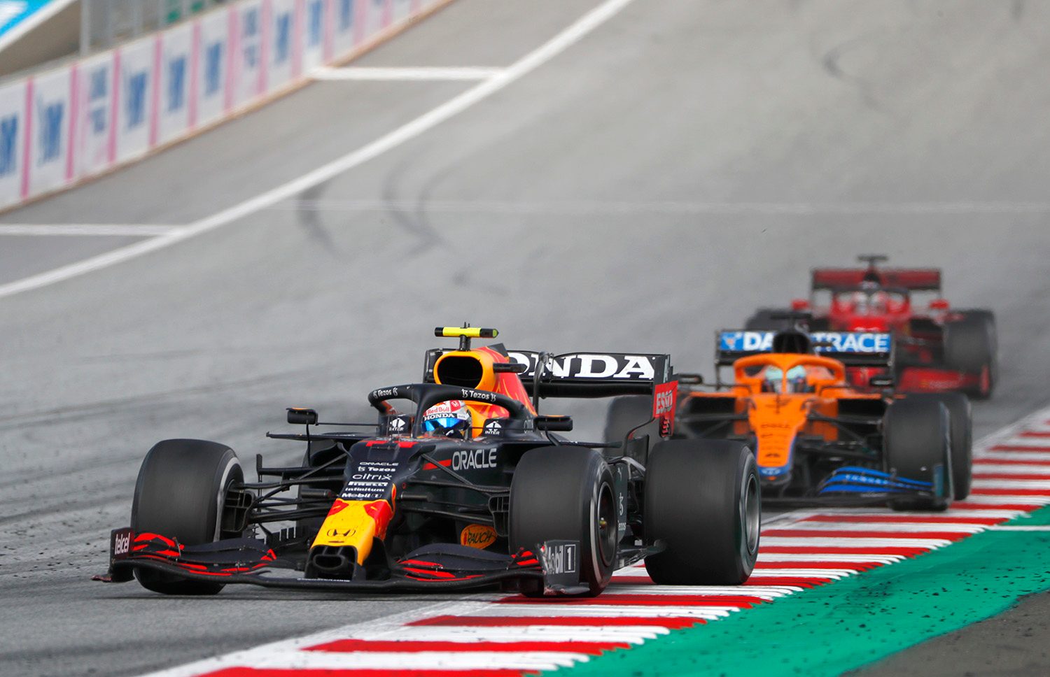 Formula One race cars on track.