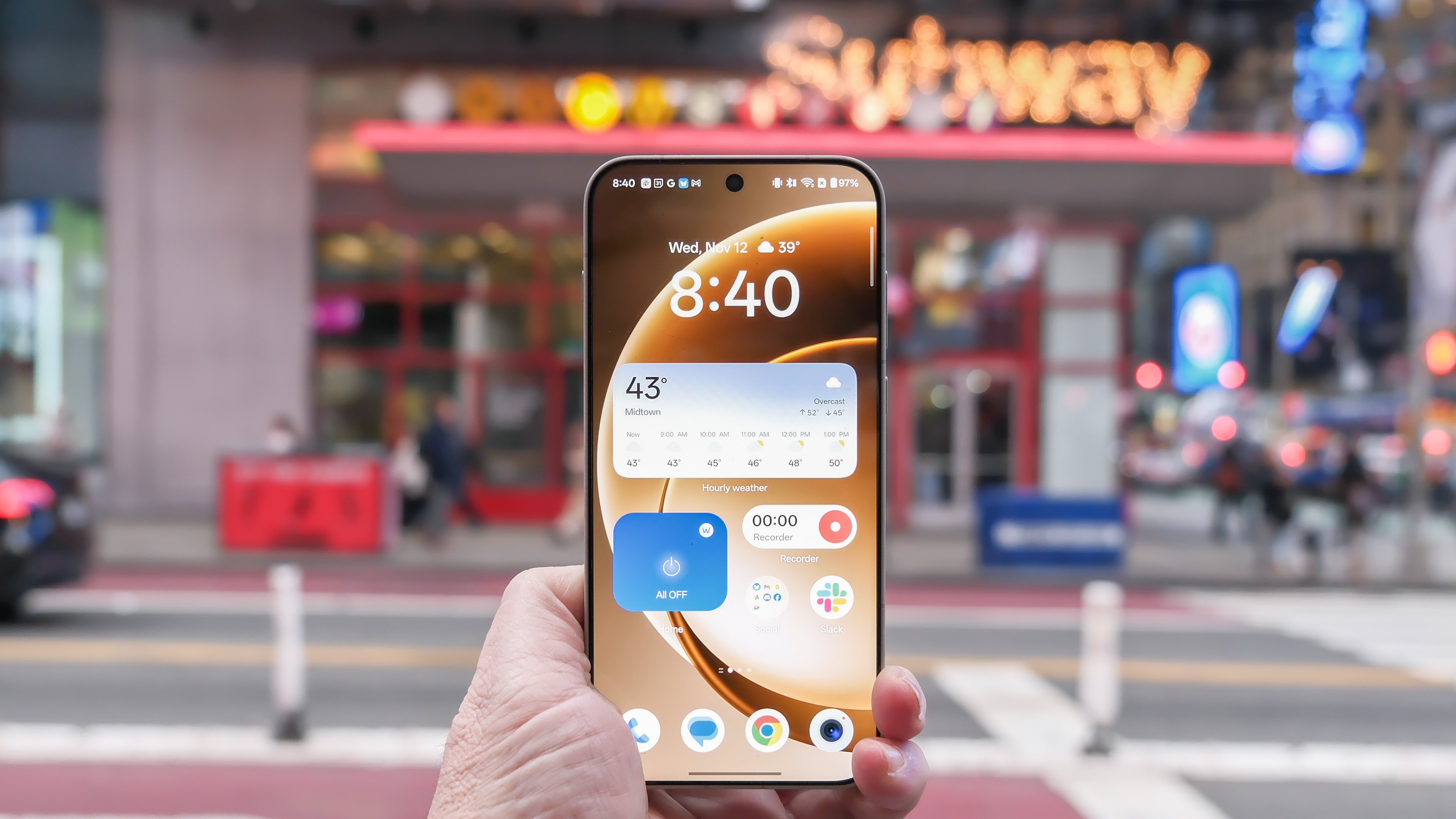 OnePlus 15 in Times Square New York City on the busy street showing the cameras and sides of the phone in addition to home screen panels and Settings menus