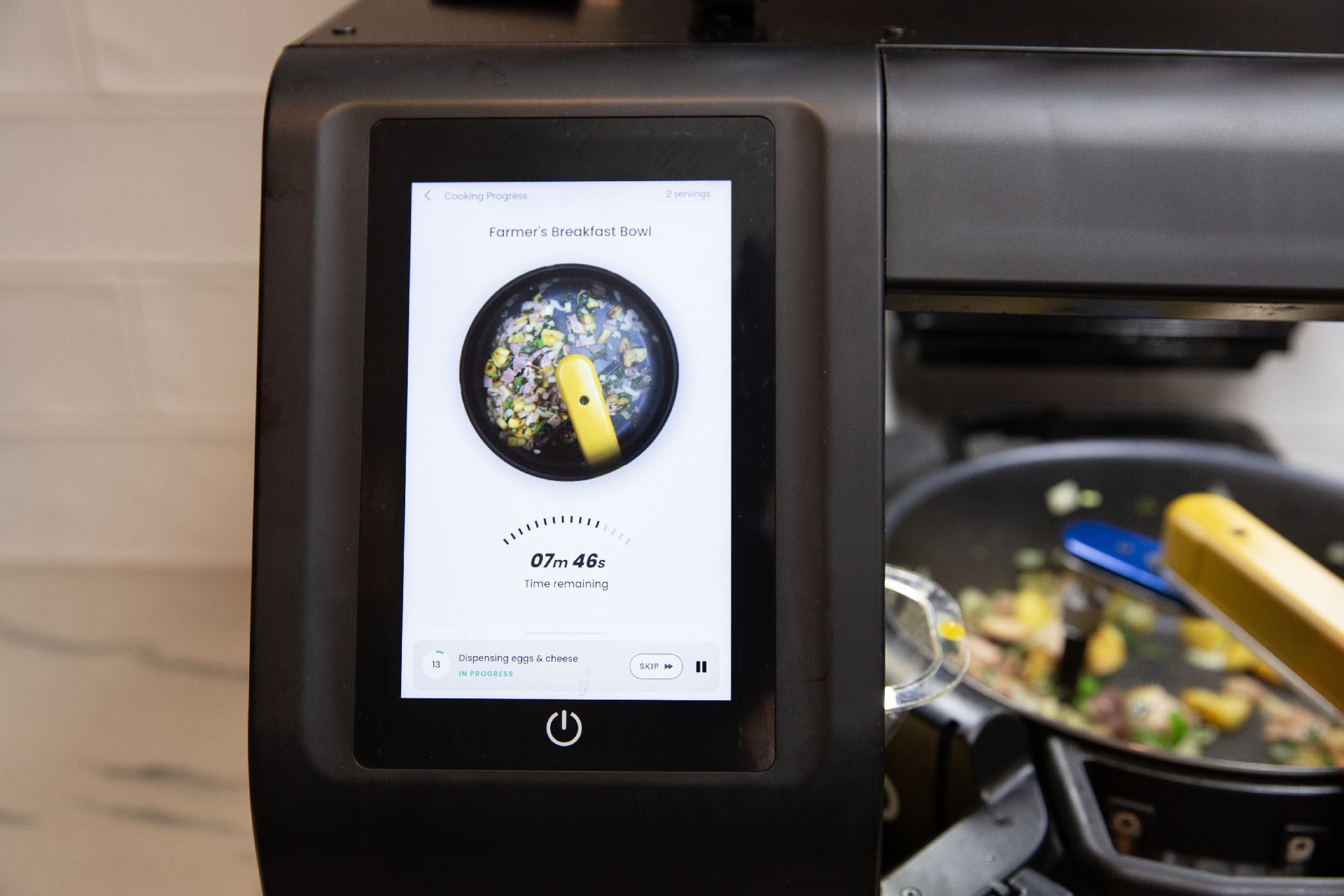 Screen showing Posha cooking robot making a “Farmer’s Breakfast Bowl”.
