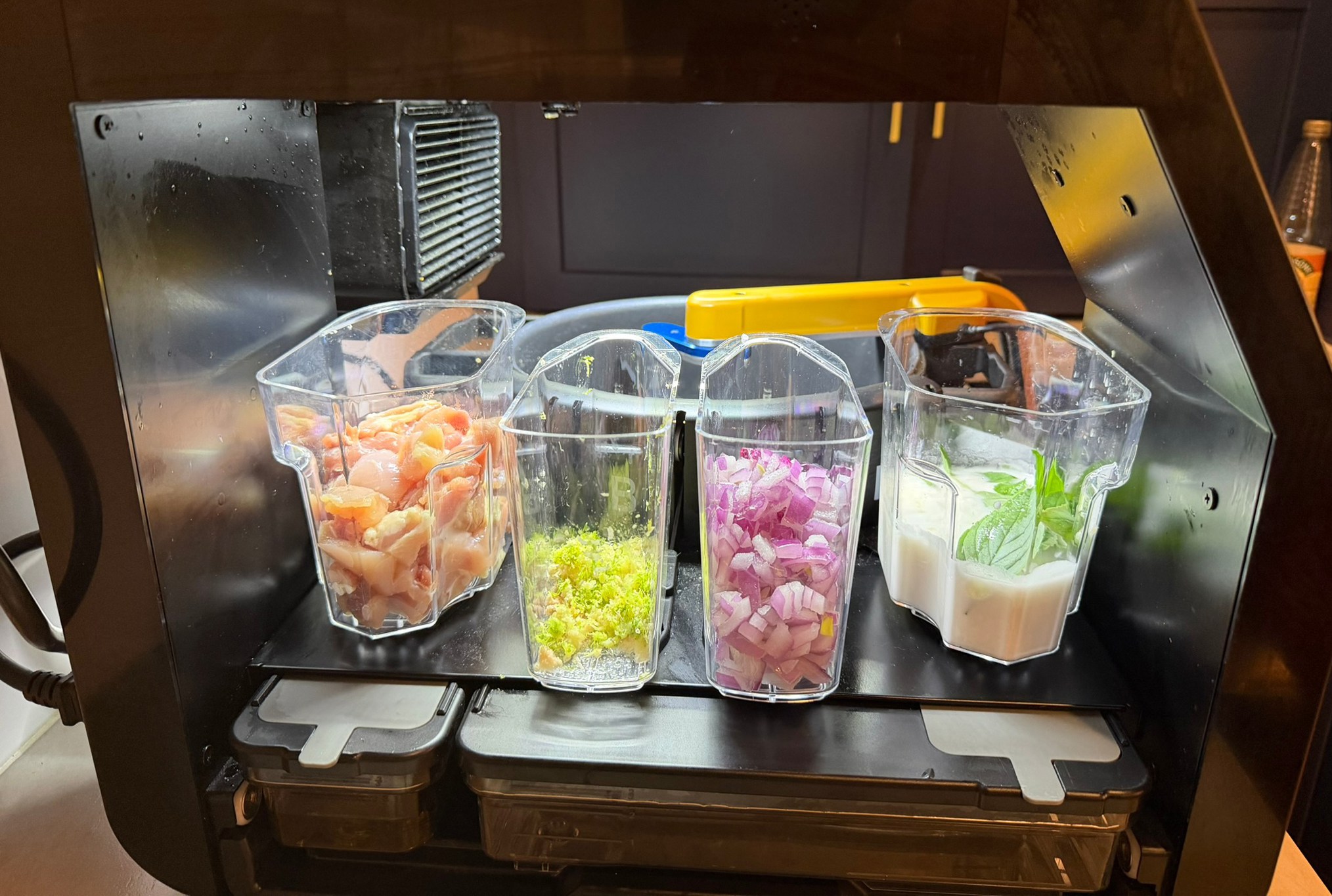 Ingredient containers on a Posha cooking robot.
