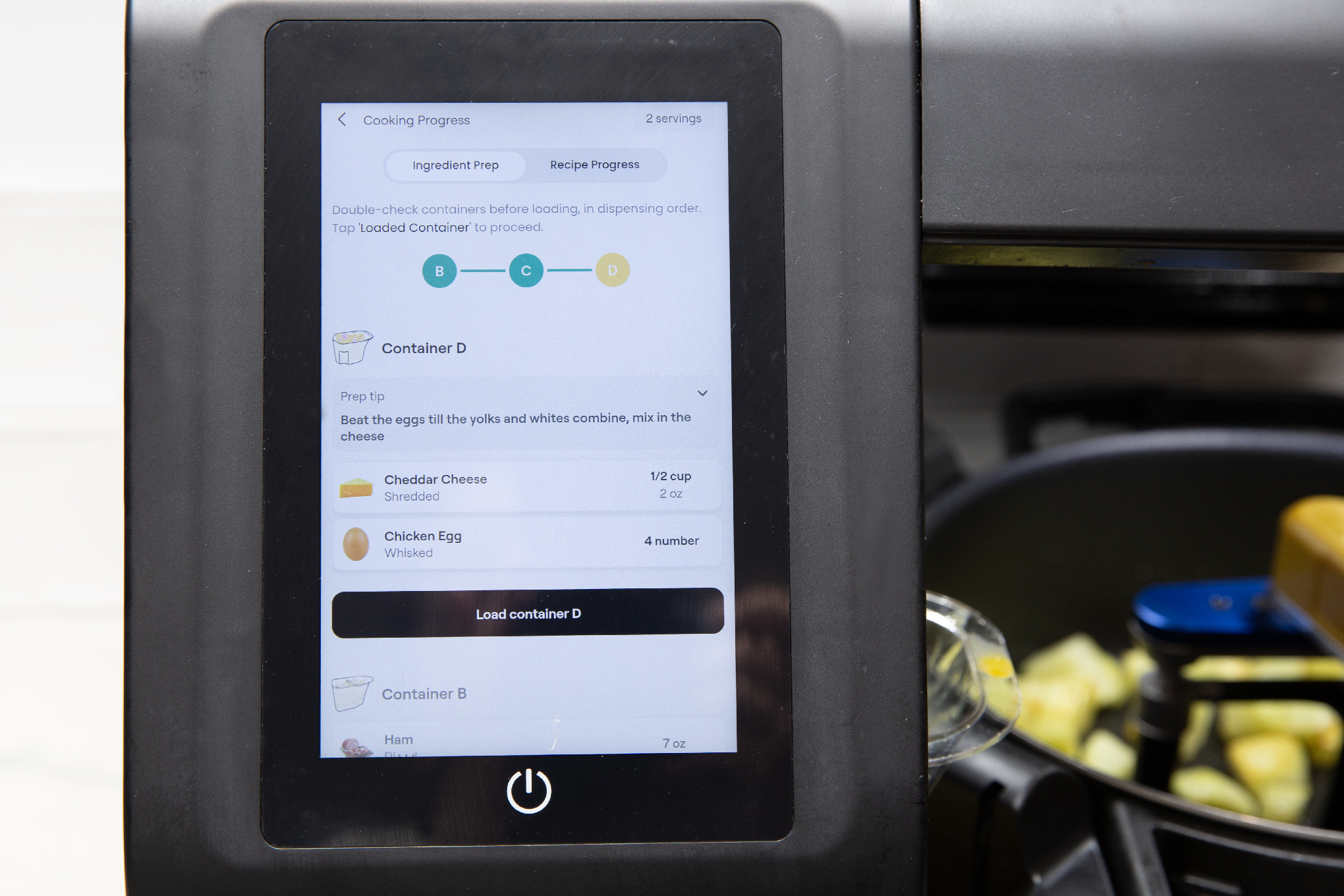 Screen on a Posha cooking robot showing incredibles and cooking steps.