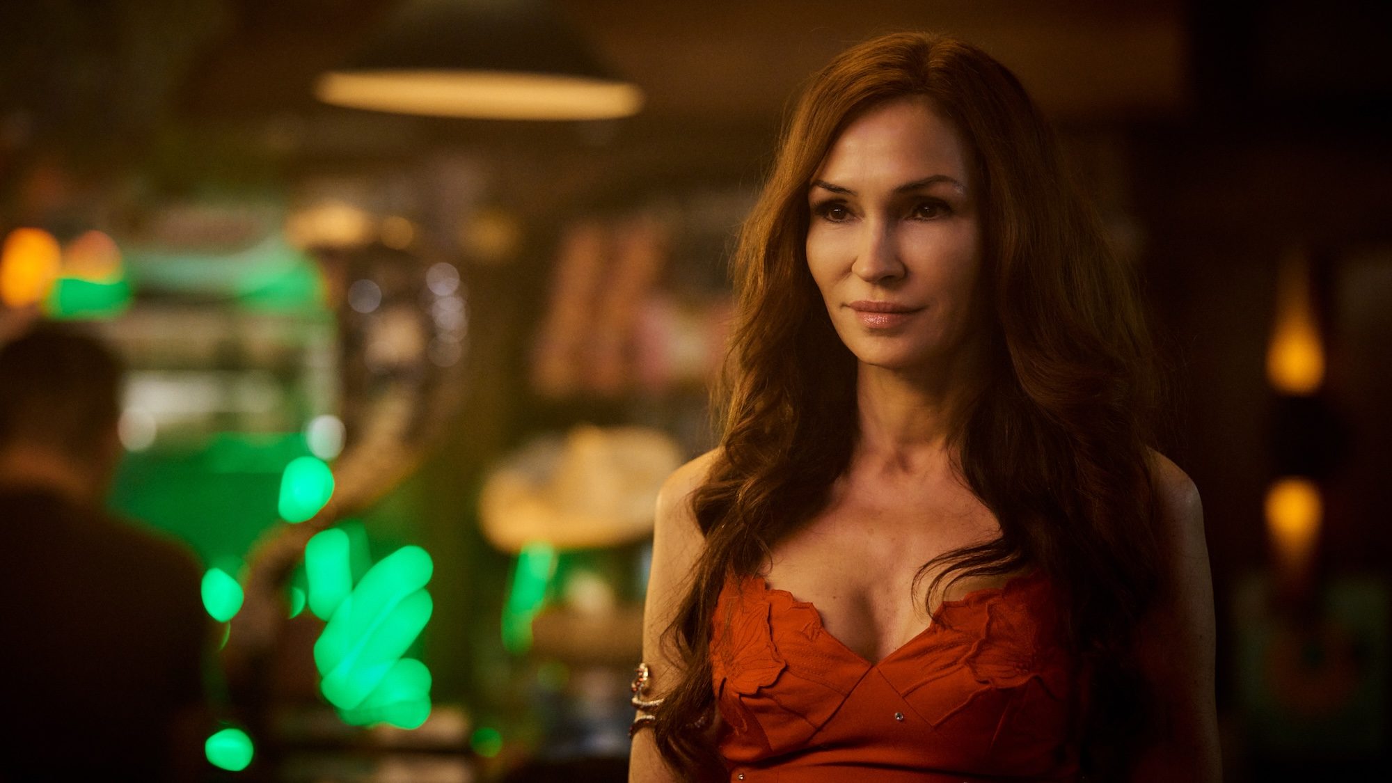 A woman stands and stares.