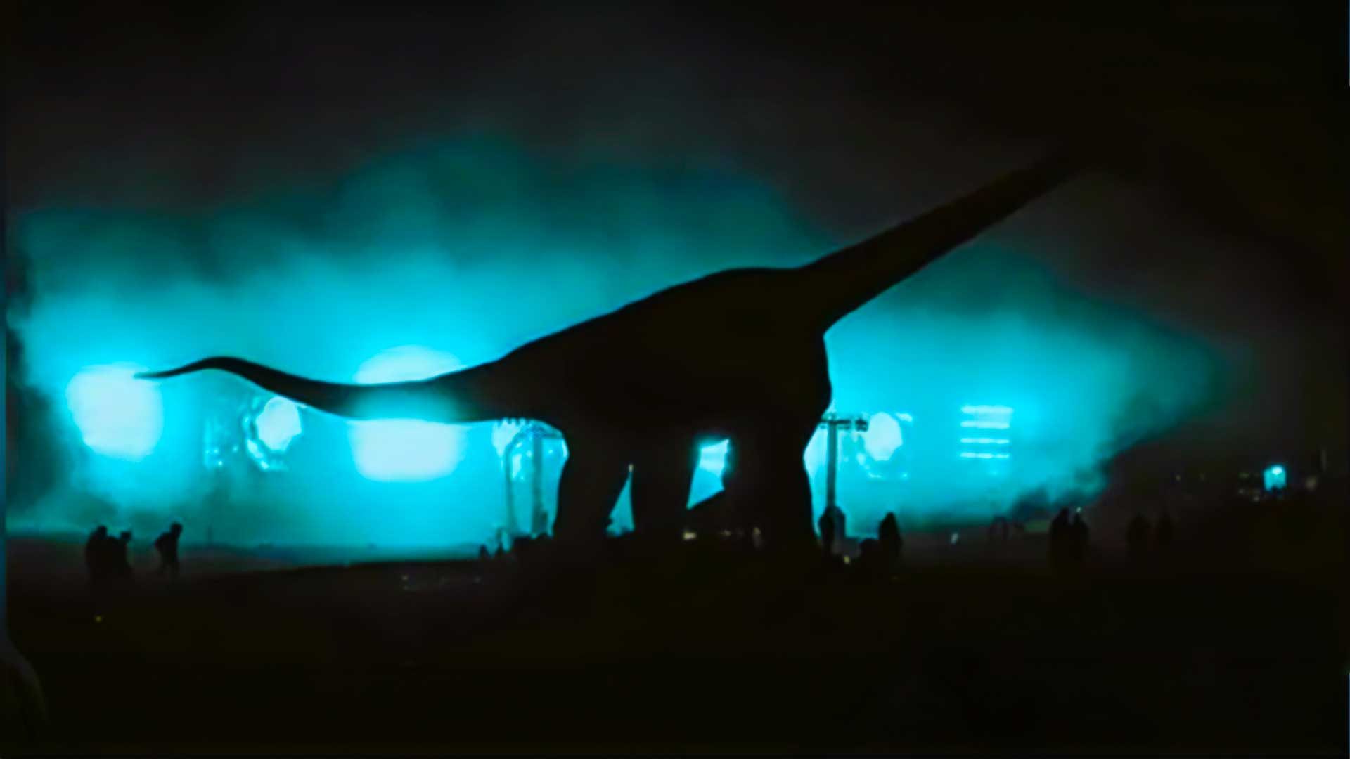 A brontosaurus standing in a field in the night in a still from the 2026 sci-fi film Flowervale Street.