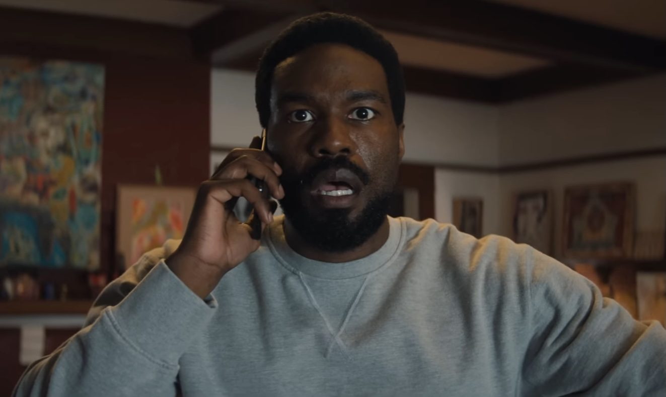 Yahya Abdul-Mateen II looking stunned while holding a phone in Wonder Man.
