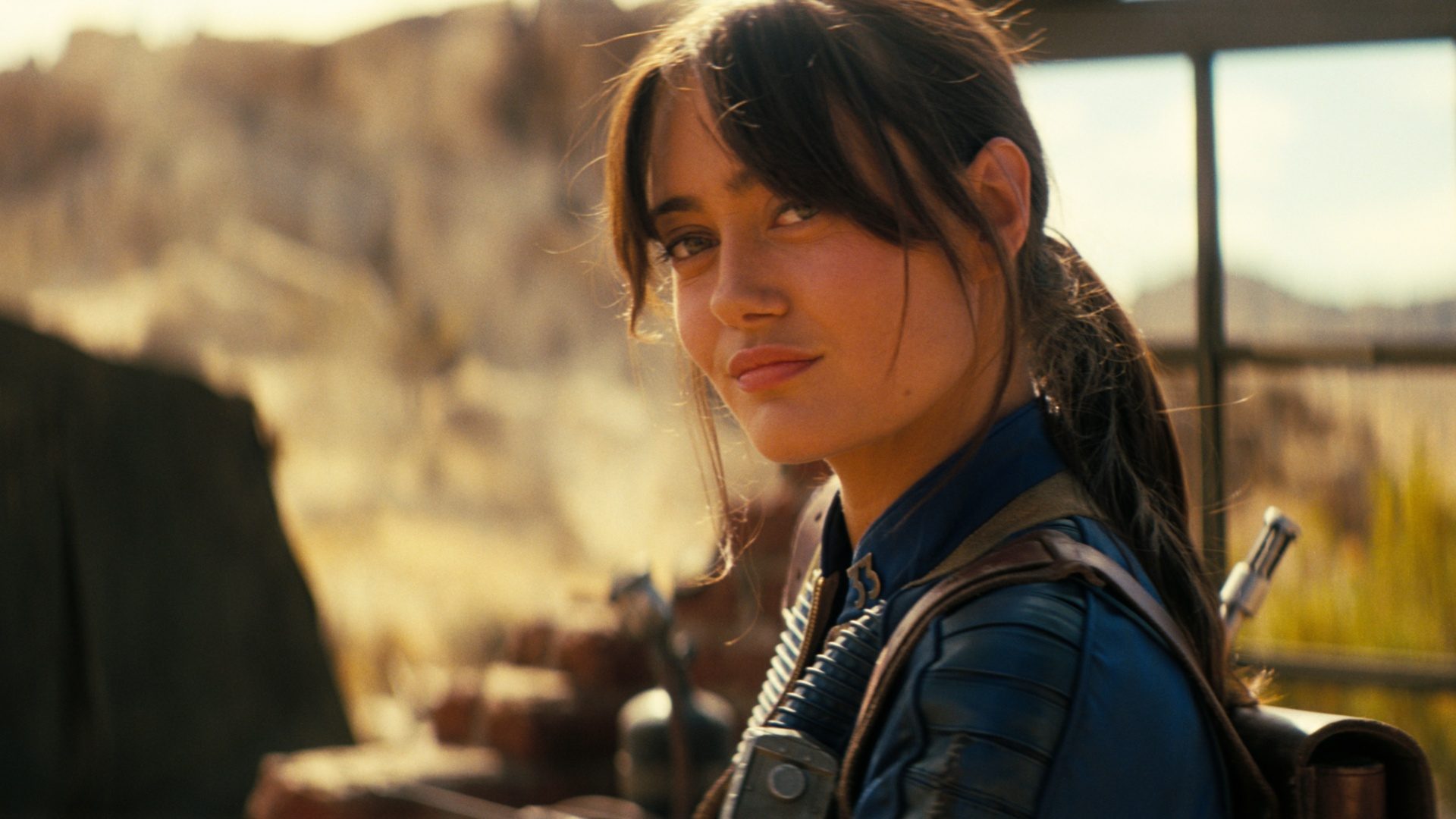 Lucy (Ella Purnell) stares and smirks in Fallout season 2.