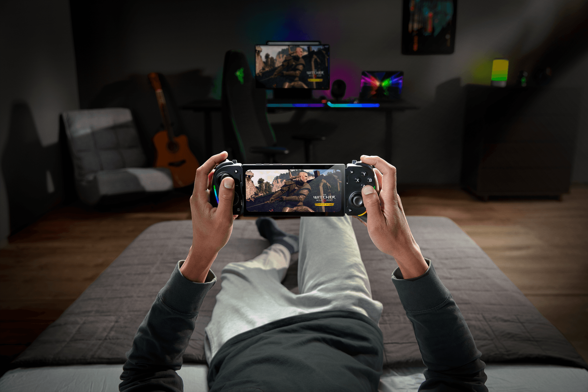 A player streams The Witcher 3 on a Kishi Ultra while laying in bed.