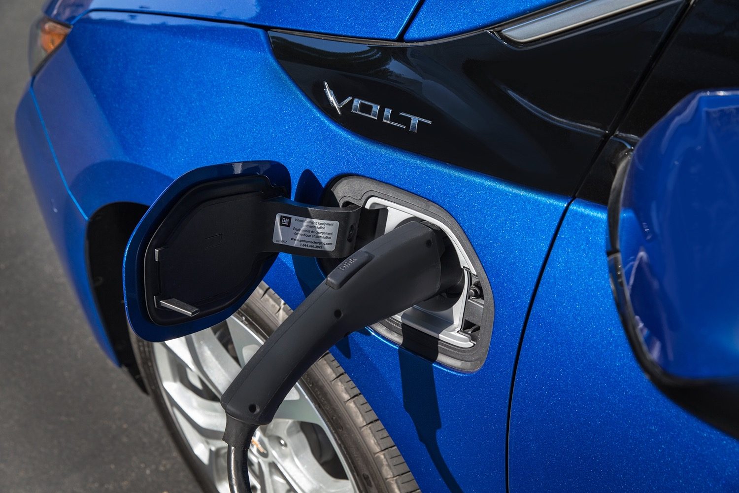 Closeup of 2016 Chevrolet Volt charge port with cable plugged in.